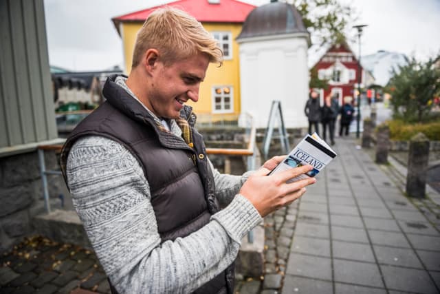 young-tourist-checks-map-iceland