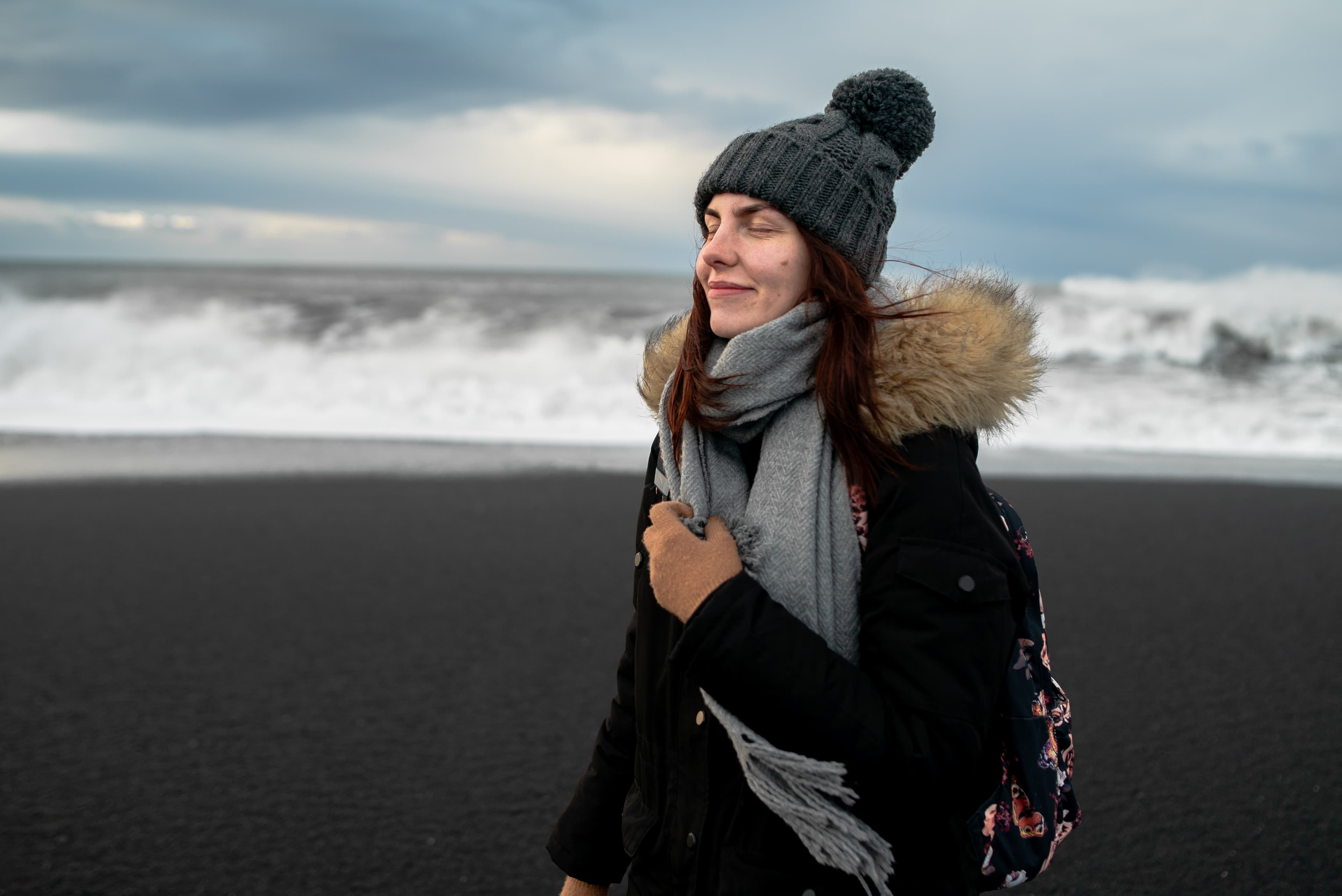 young-woman-walks-black-beach