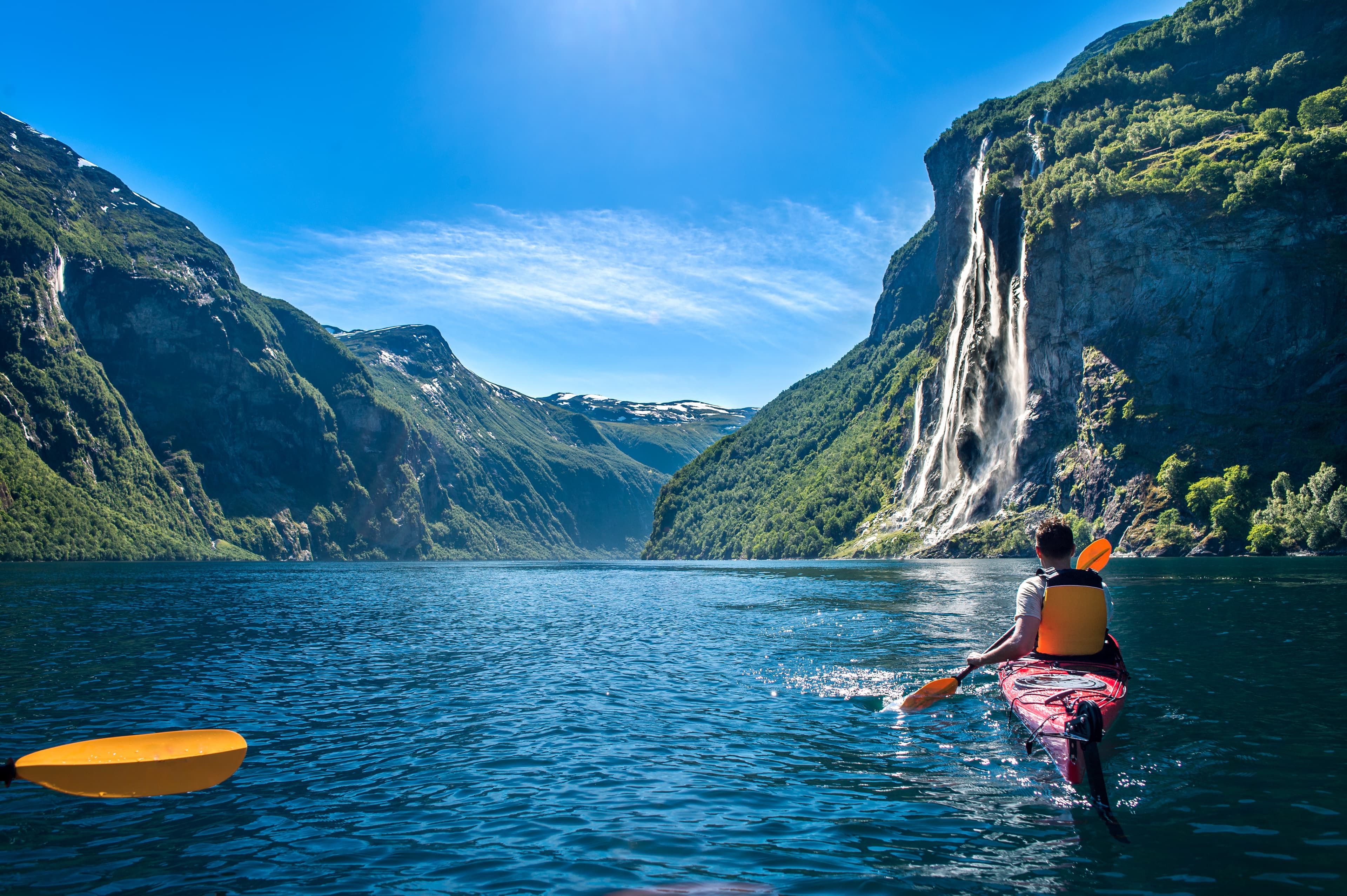man kayaking along the fjord