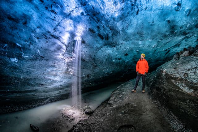 Man-with-Red-Jacket-in-Blue-Ice-Cave
