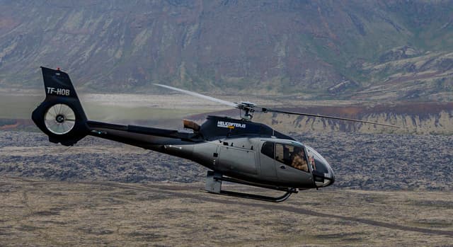 Helicopter-flying-above-lava-fields