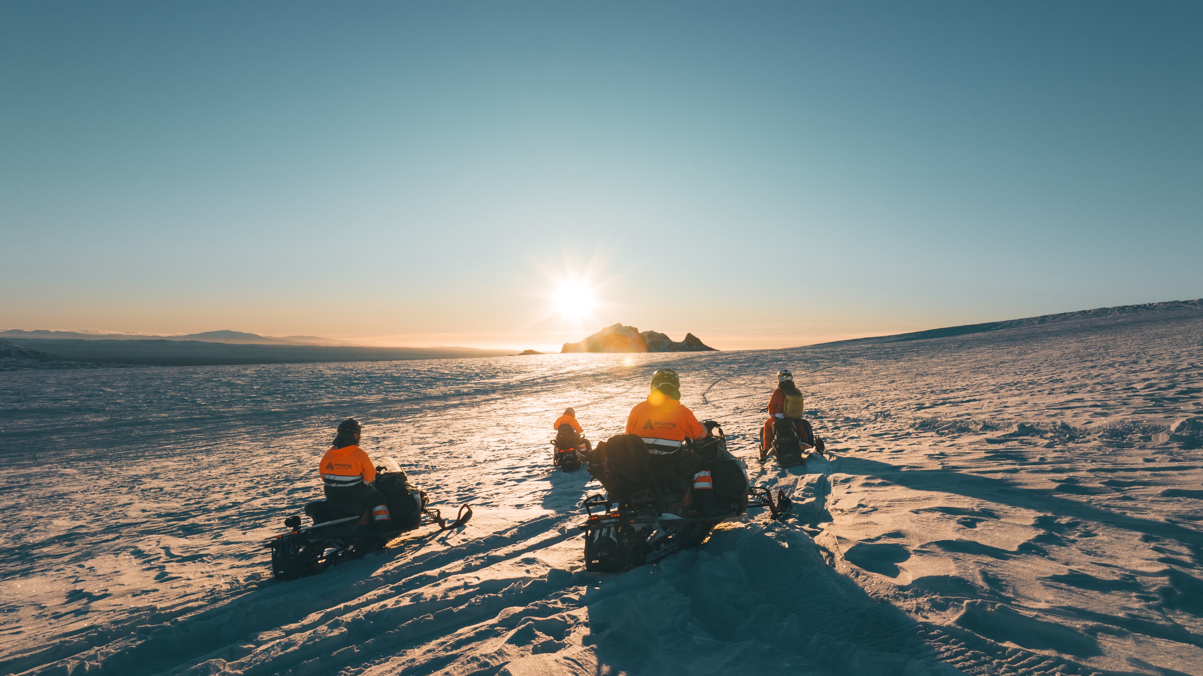 snowmobiles-sunset