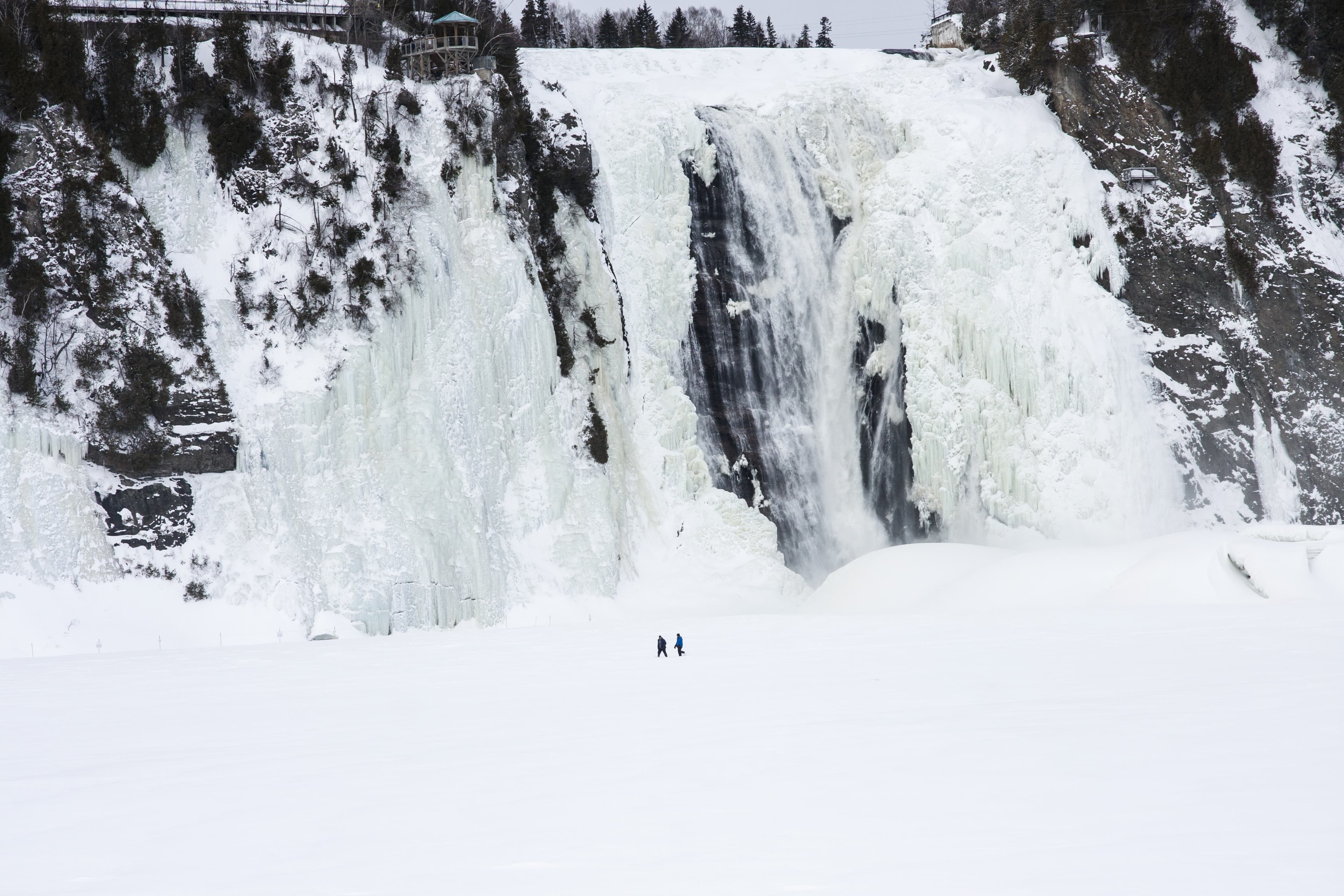 Men's walking on frozen waterfalls