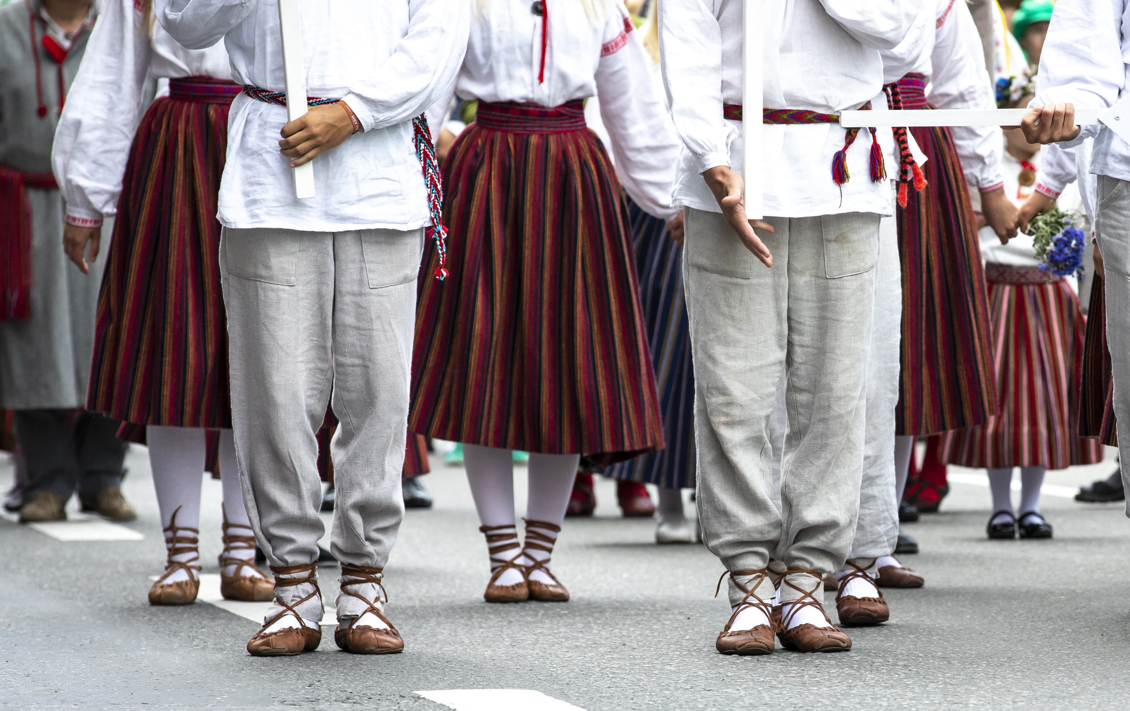feet of estonian folk dancers estonian people in traditional clothing walking the streets of Tallinn