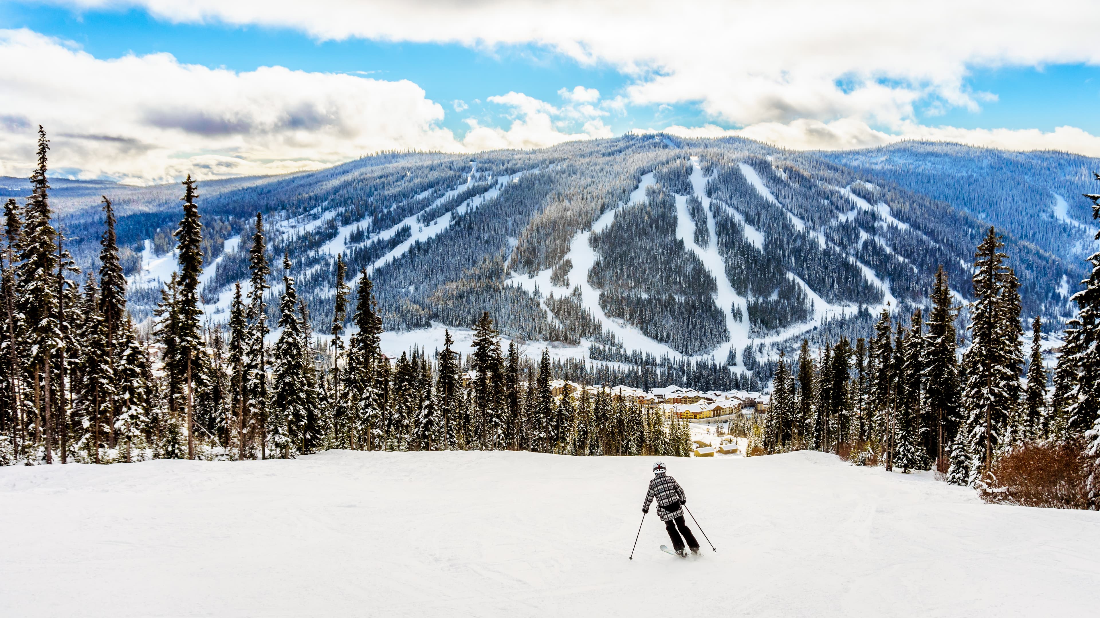 Skiing down to the village of Sun Peaks in the Shuswap Highlands of central British Columbia, Canada
