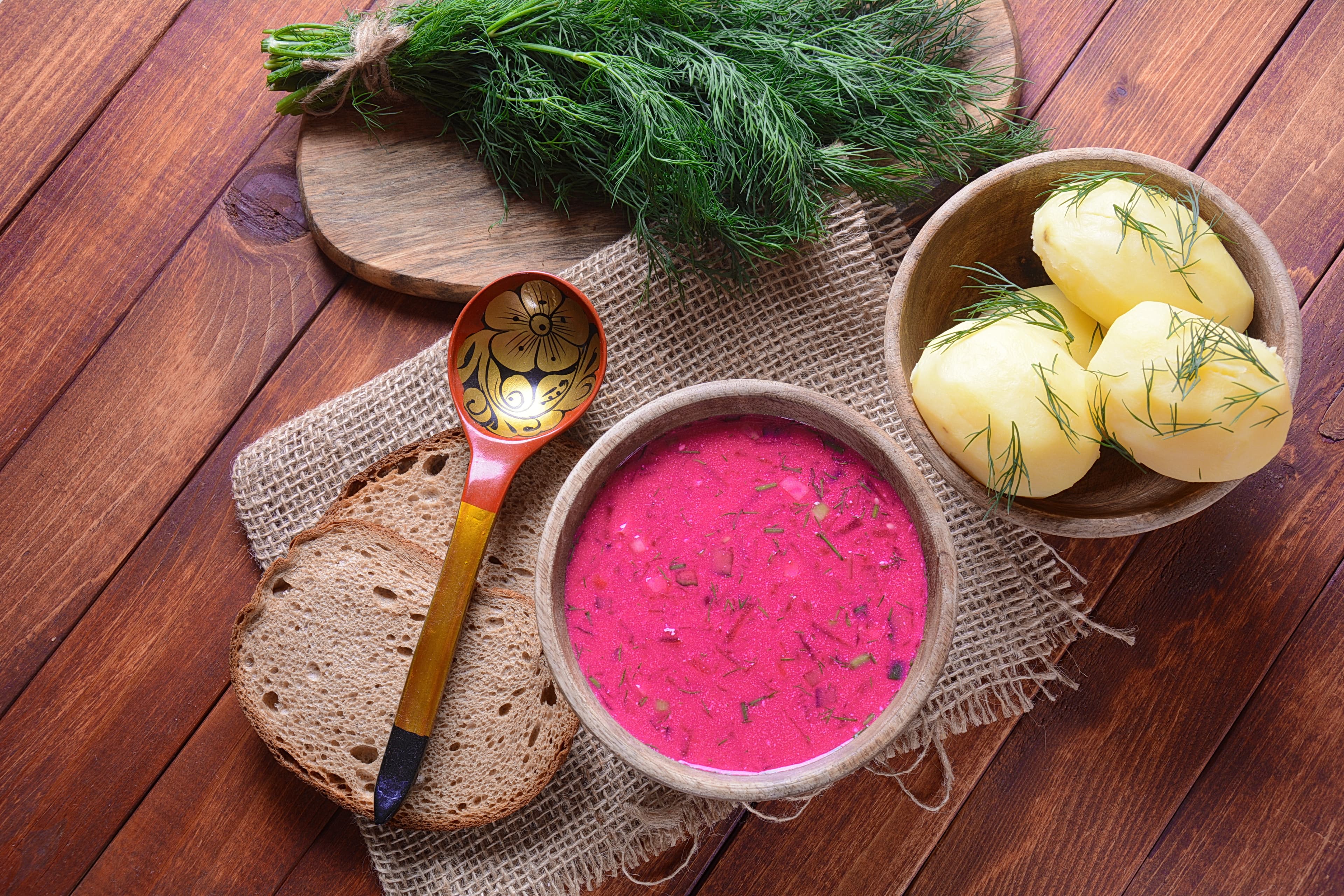 Traditional Belorussian, Latvian, Lithuanian, Polish, Russian and Ukrainian Beetroot cold creamy soup with cucumber, radish, potatoes and egg . Summer soup concept