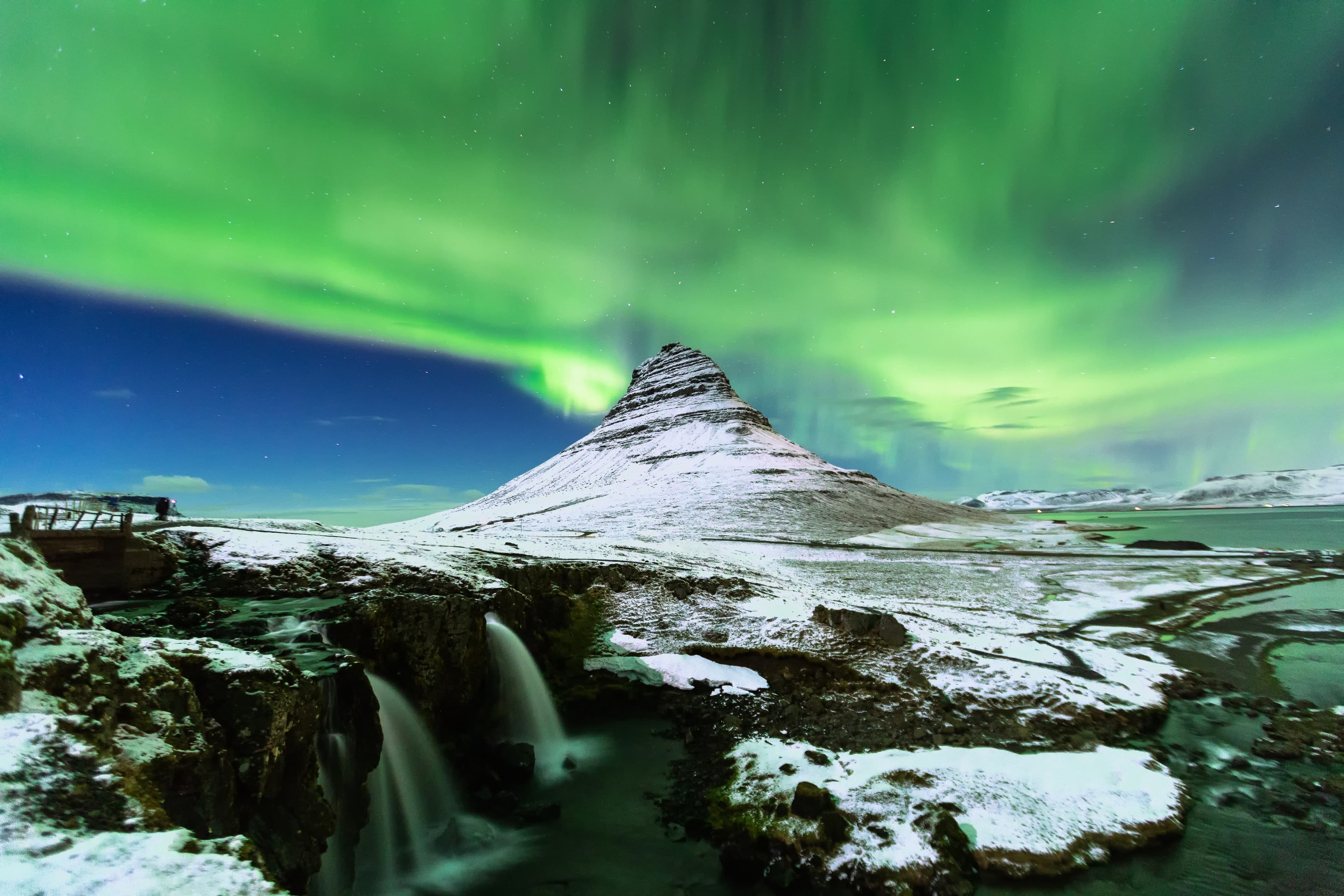 Aurora Borealis or northern light above kirkjufell mountain in iceland Iceland-Kirkjufell-mountain-covered-in-snow-with-northern-lights-above
