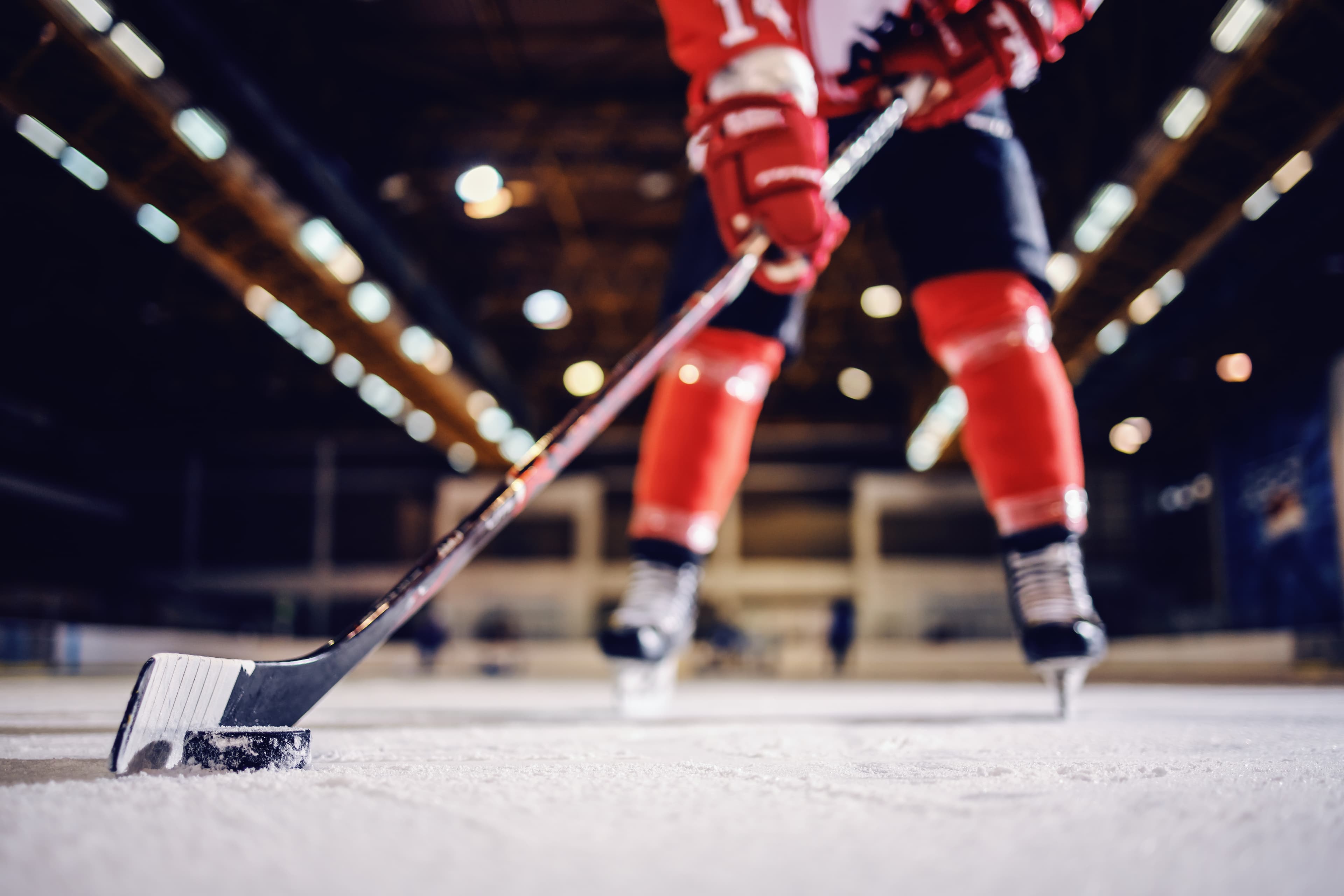 Close up of hockey player skating with stick and puck. Close up of hockey player skating with stick and puck.