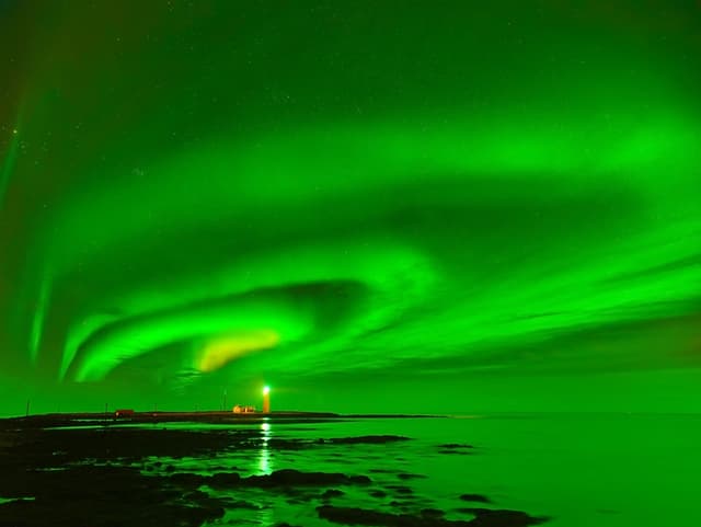 View of the northern light at Grotta Lighthouse in Reykjavik, Iceland.
