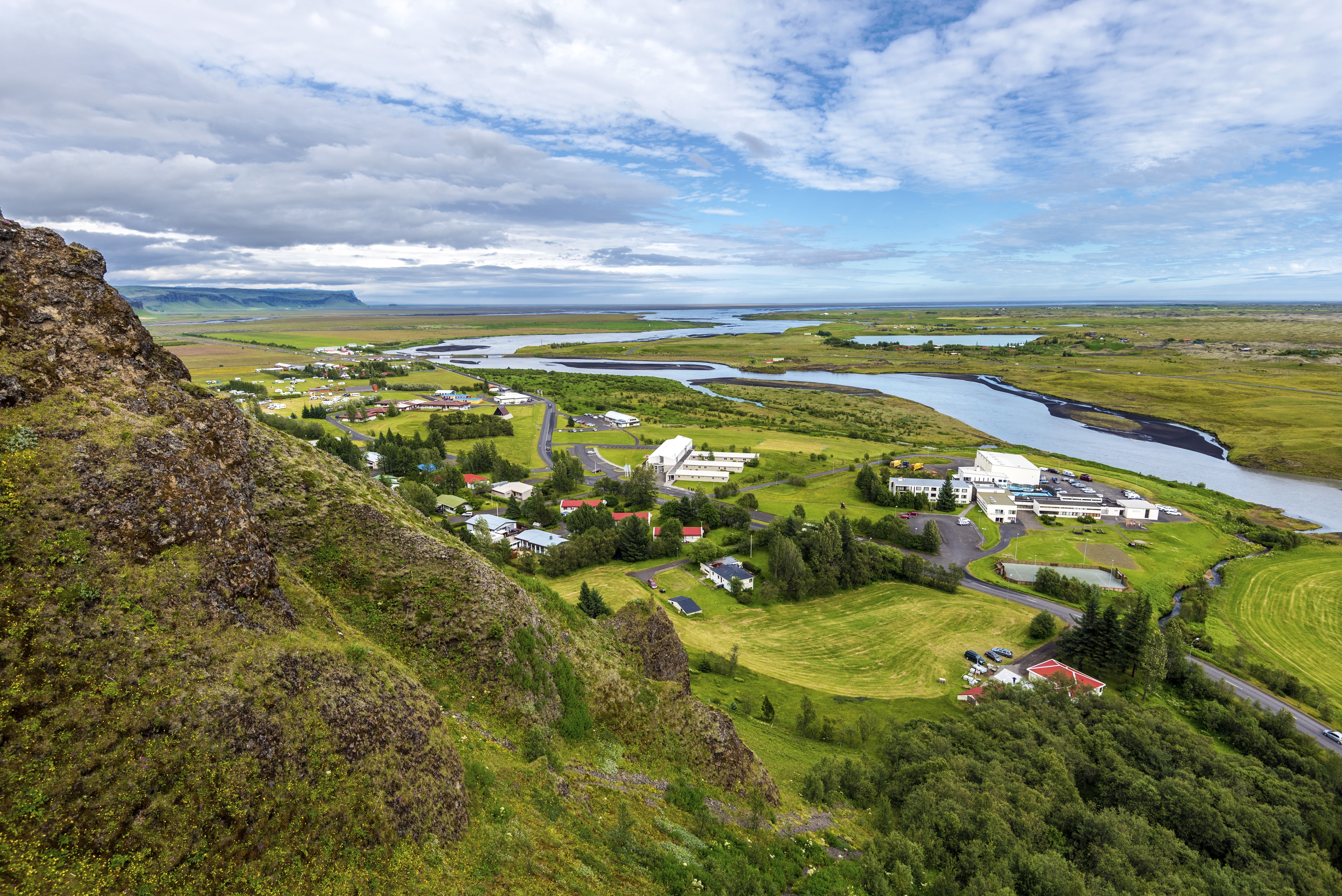 Kirkjubaejarklaustur village in Skaftarhreppur municipality of Southern Iceland. The flow of Skafta river to rejoin the Atlantic Ocean at horizon.  Kirkjubaejarklaustur village in Skaftarhreppur municipality of Southern Iceland.