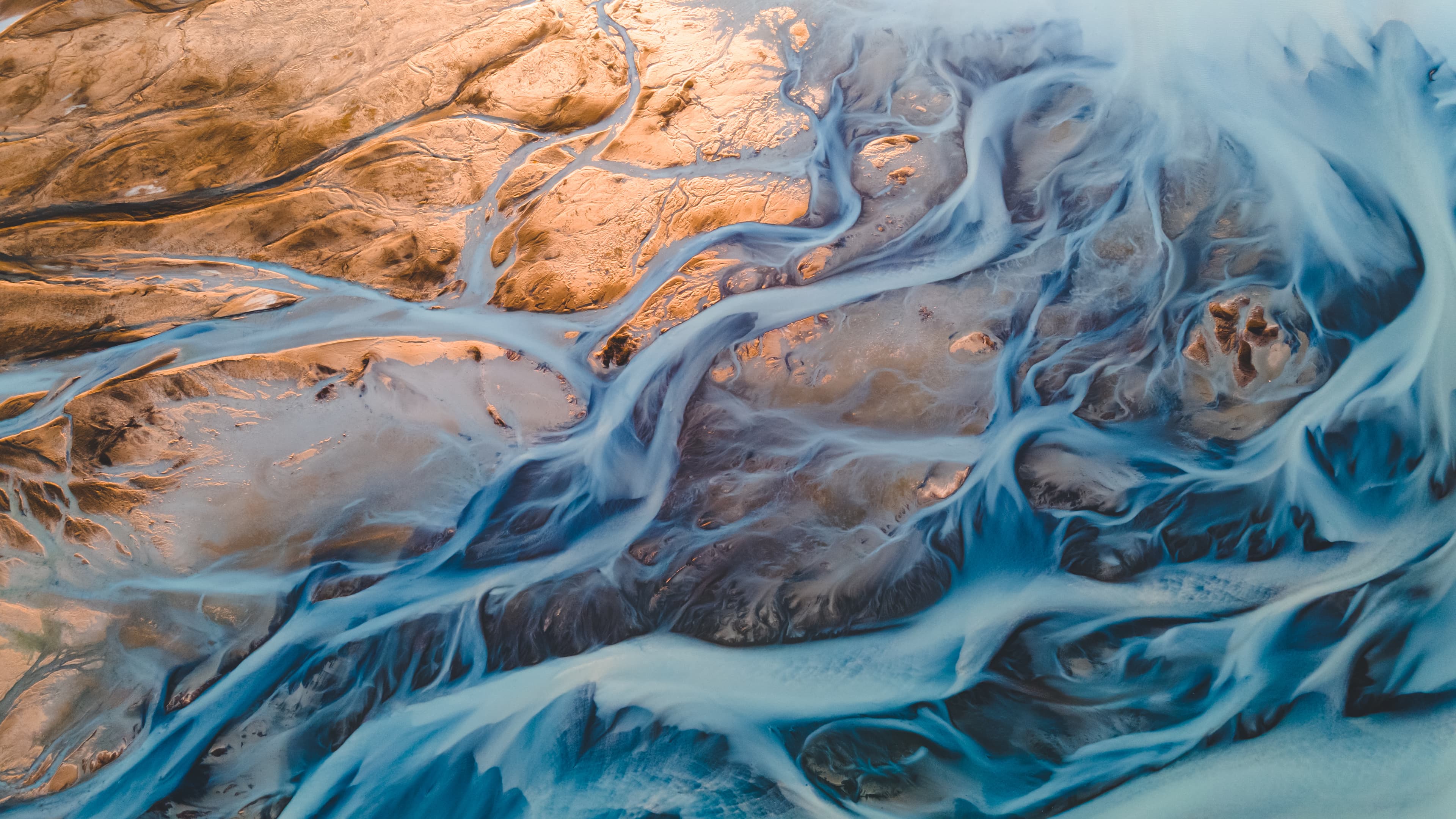 A glacial rivers from above. Aerial photograph of the river streams from Icelandic glaciers. Beautiful art of the Mother nature created in Iceland. Wallpaper background high quality photo. A glacial rivers from above. Aerial photograph of the river streams from Icelandic glaciers. Beautiful art of the Mother nature created in Iceland. Wallpaper background high quality photo