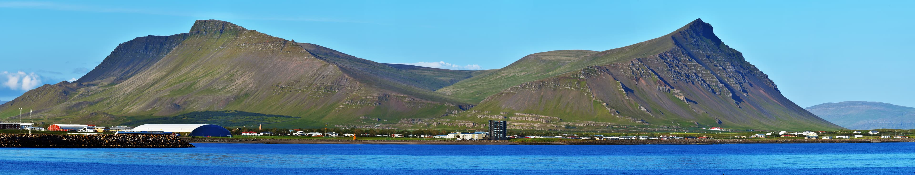 Panoramic view at Akrafjall mountain and Akranes town in the border of  Faxa Bay in Vesturland region of Iceland. Viewed from Sudurflos reef. Panoramic view at Akrafjall mountain and Akranes town in the border of  Faxa Bay in Vesturland region of Iceland.