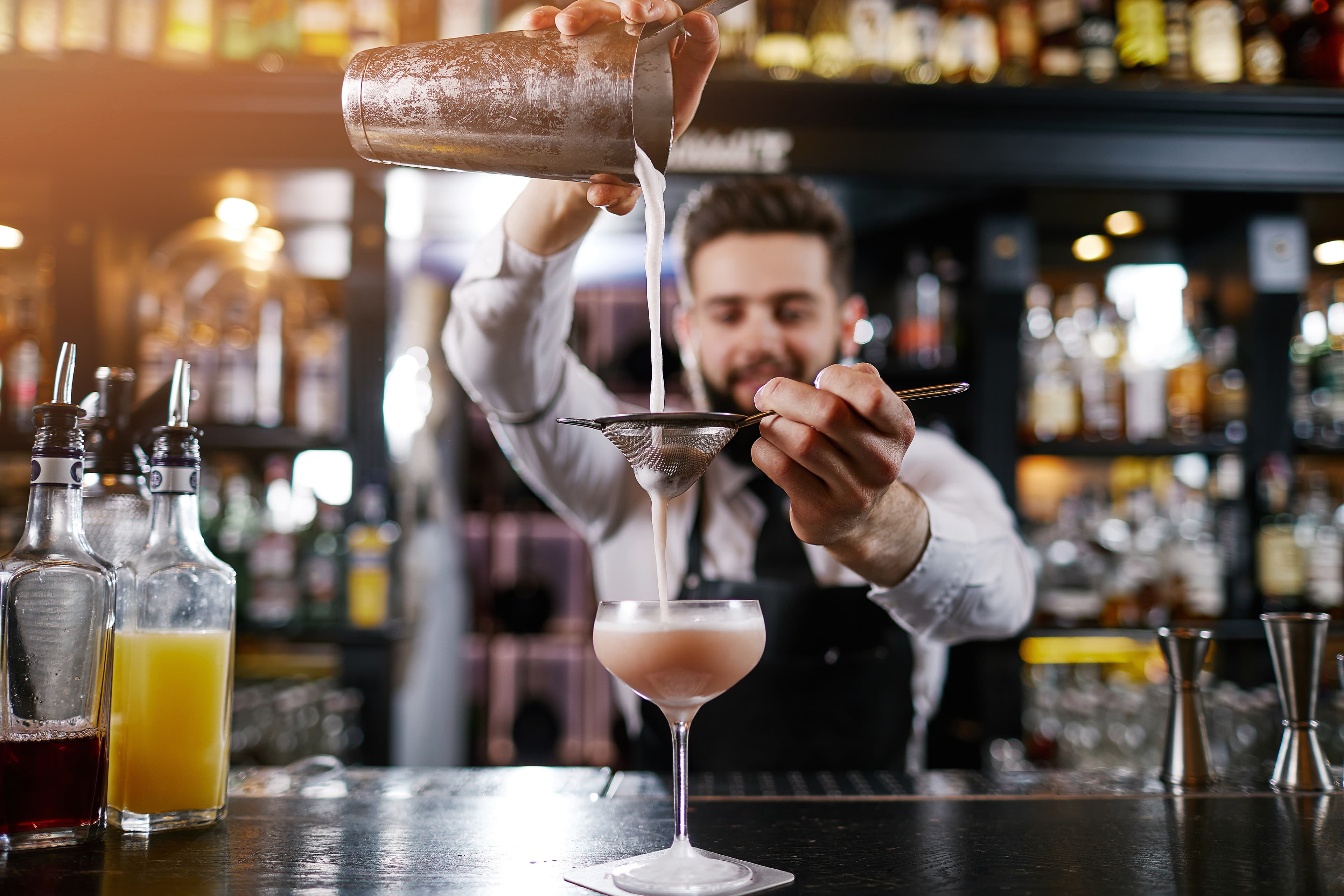 Professional bartender is making cocktail at night club Professional bartender is making cocktail at night club