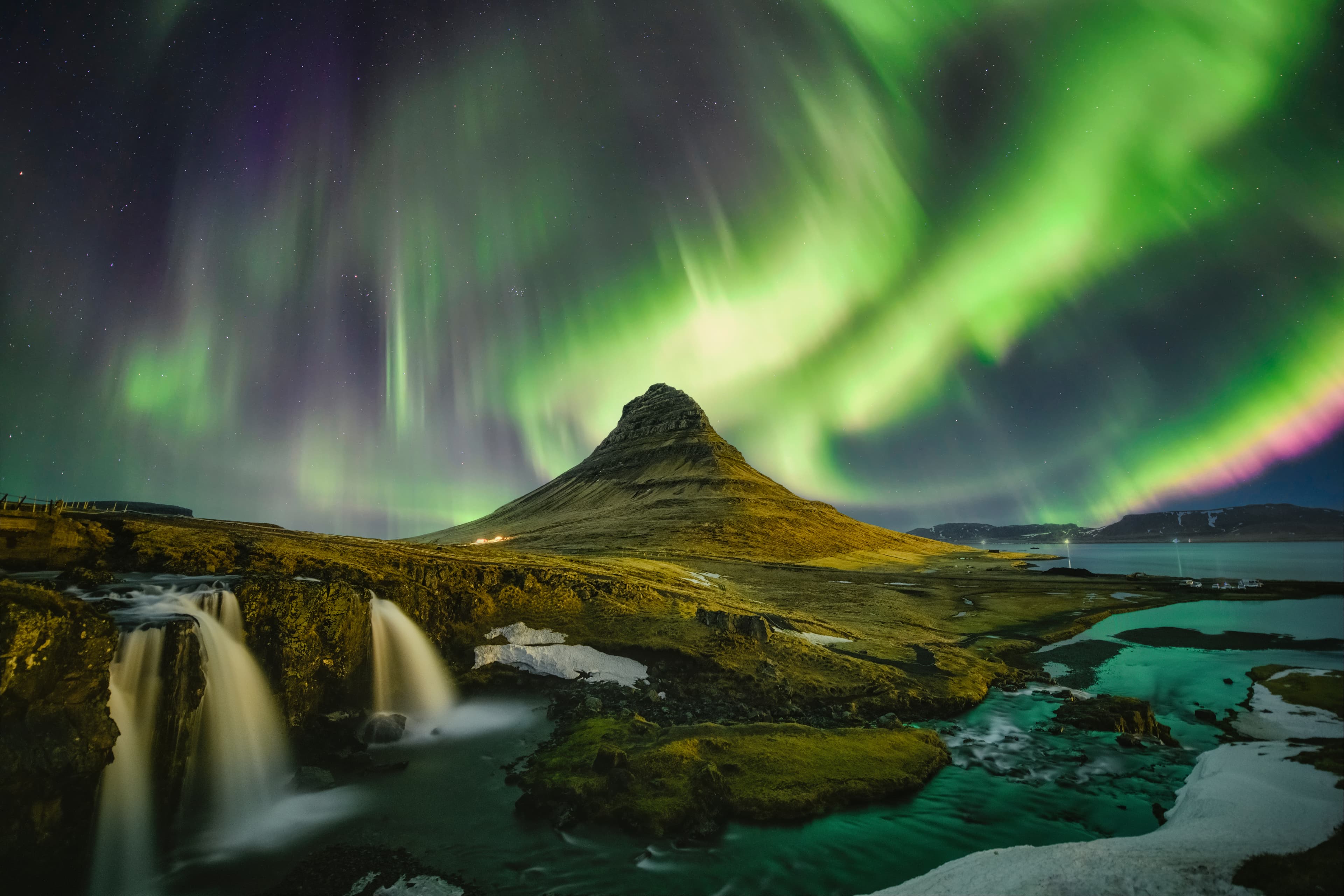 Kirkjufell Waterfall under aurora in winter season Iceland-Kirkjufell-mountains-and-bright-northern-lights