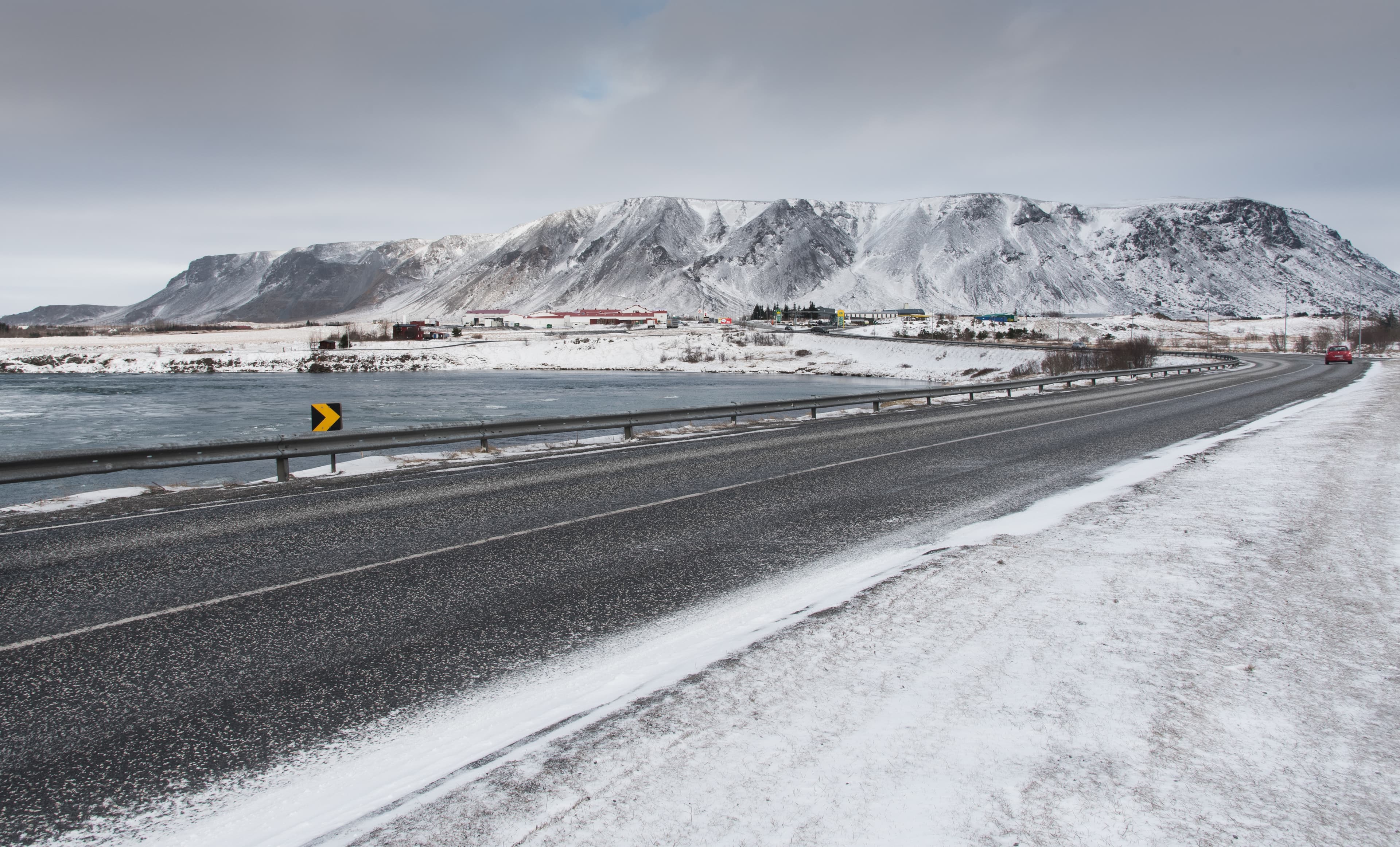 Frozen  road leading to the snowy mountains at Selfoss town in  Iceland Winter asphalt frozen  road,  Selfoss city iceland