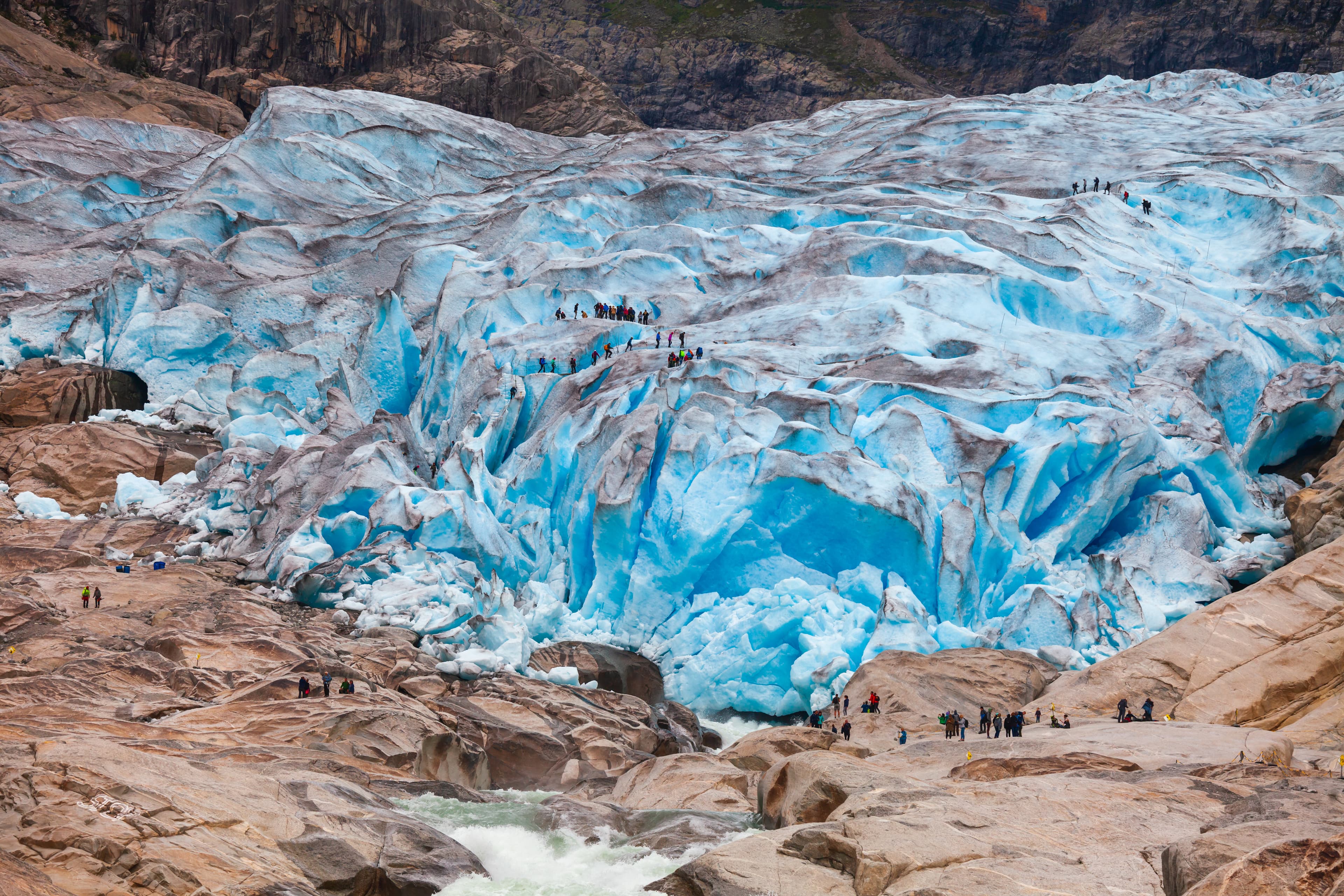 Tourists visit the Nigardsbreen Glacier, an arm of the Jostedalsbreen glacier, Jostedalsbreen National Park, Sogn og Fjordane, Norway, Scandinavia Visitors at Nigardsbreen glacier Jostedalsbreen National Park Sogn og Fjordane Norway Scandinavia