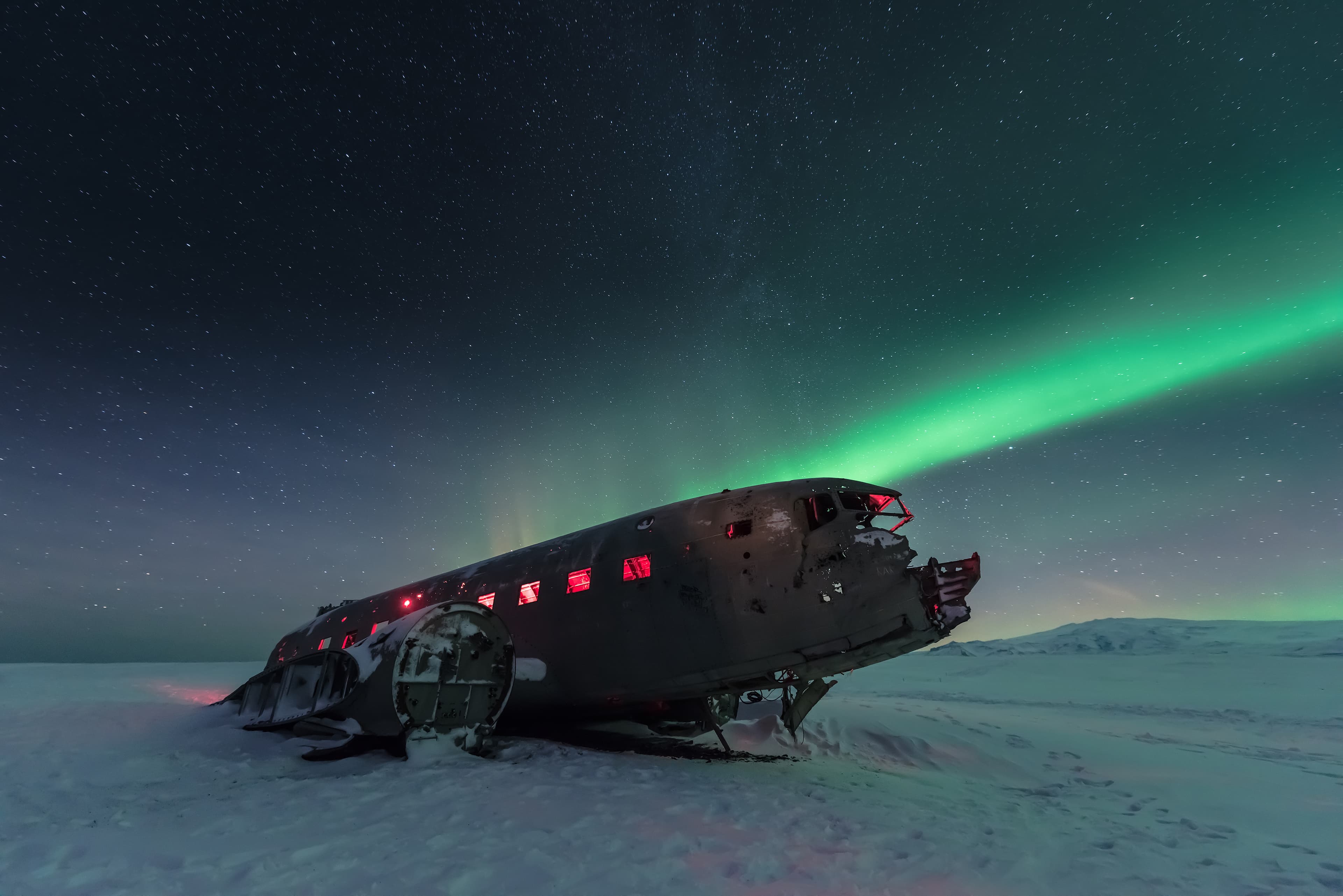 northern lights over plane wreck  in Vik, Iceland