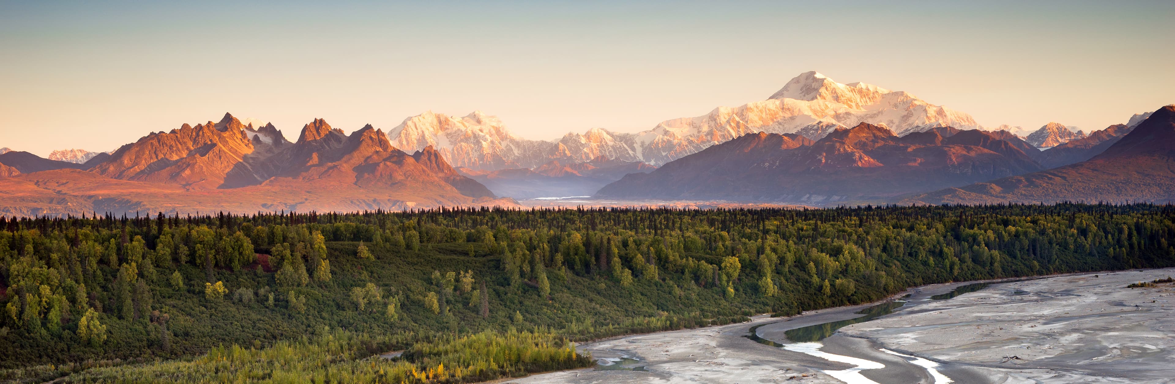 The sun finally meets the horizon hitting Mount McKinley and the Denali range on a long summer day in Alaska Denali Range Mt McKinley Alaska North America