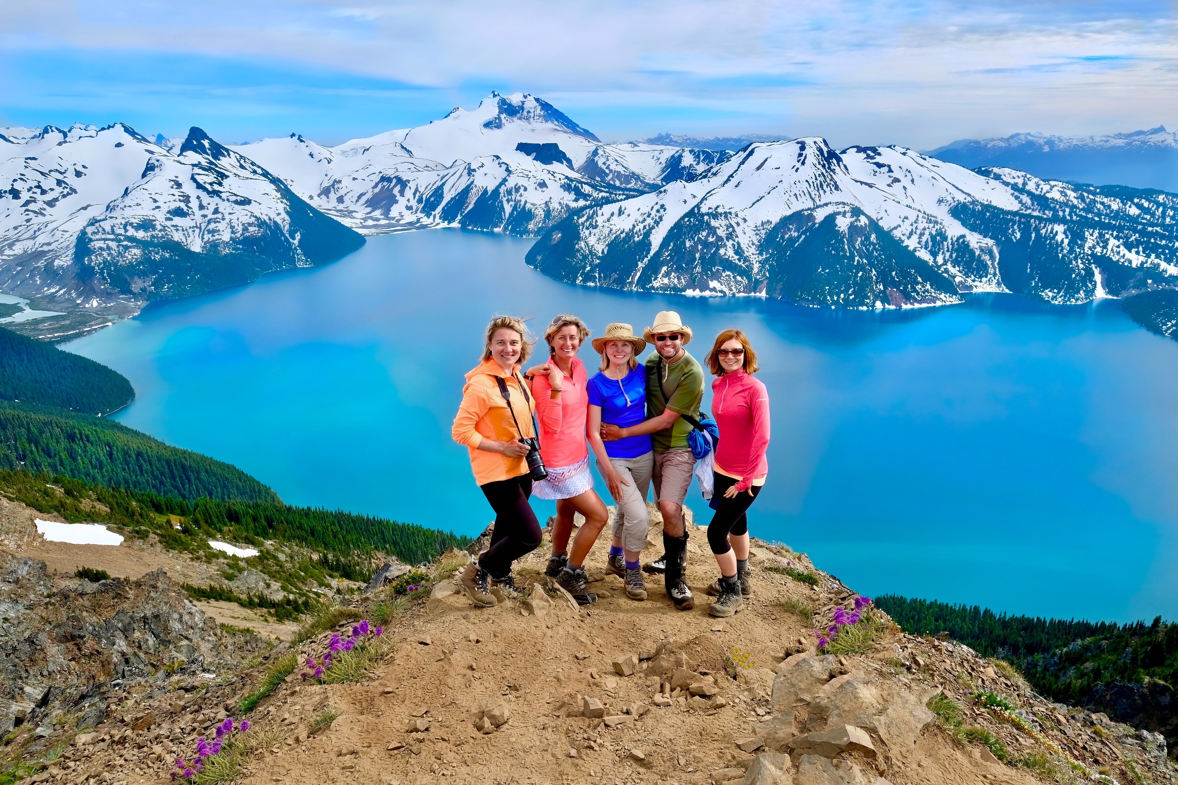 Group of friends on mountain top looking happy, energetic and successful.  Garibaldi Provincial Park. British Columbia. Canada