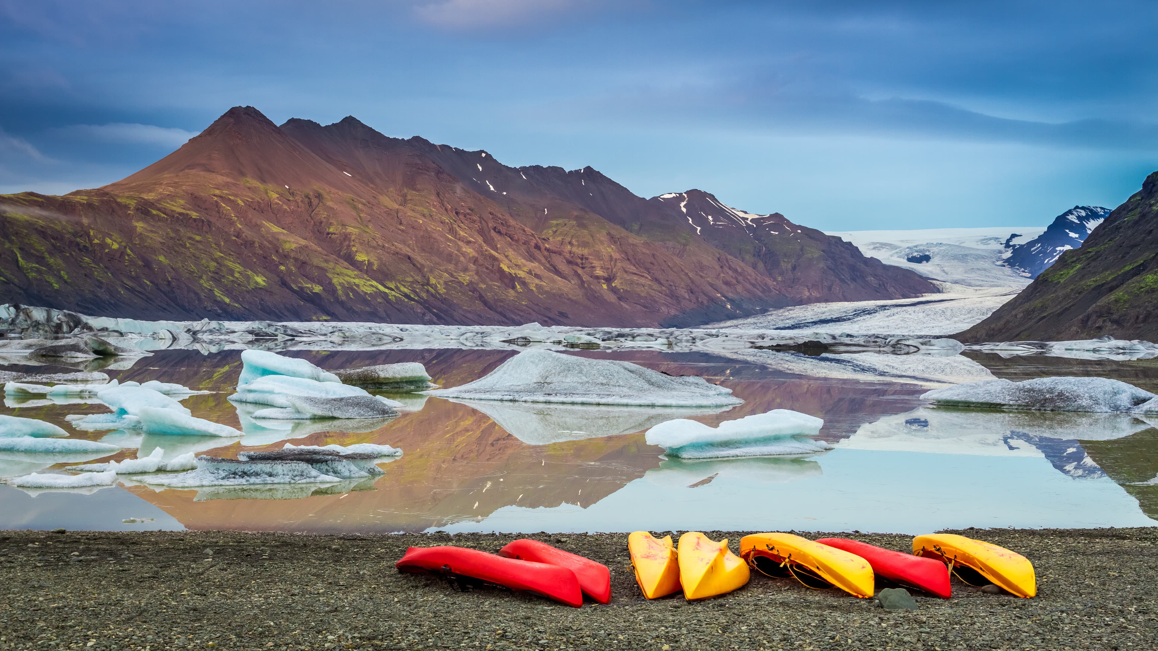 Kayaks at glacial lake in the cold mountains, Iceland Kayaks at glacial lake in the cold mountains, Iceland