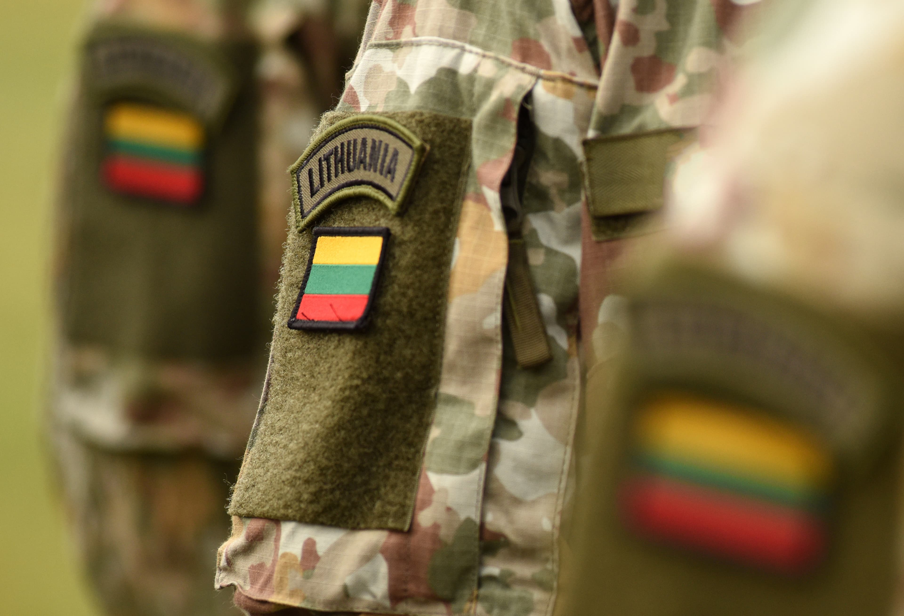 Lithuania patch flag on soldiers arm. Lithuanian military uniform. Lithuania troops Lithuania patch flag on soldiers arm. Lithuanian military uniform. Lithuania troops