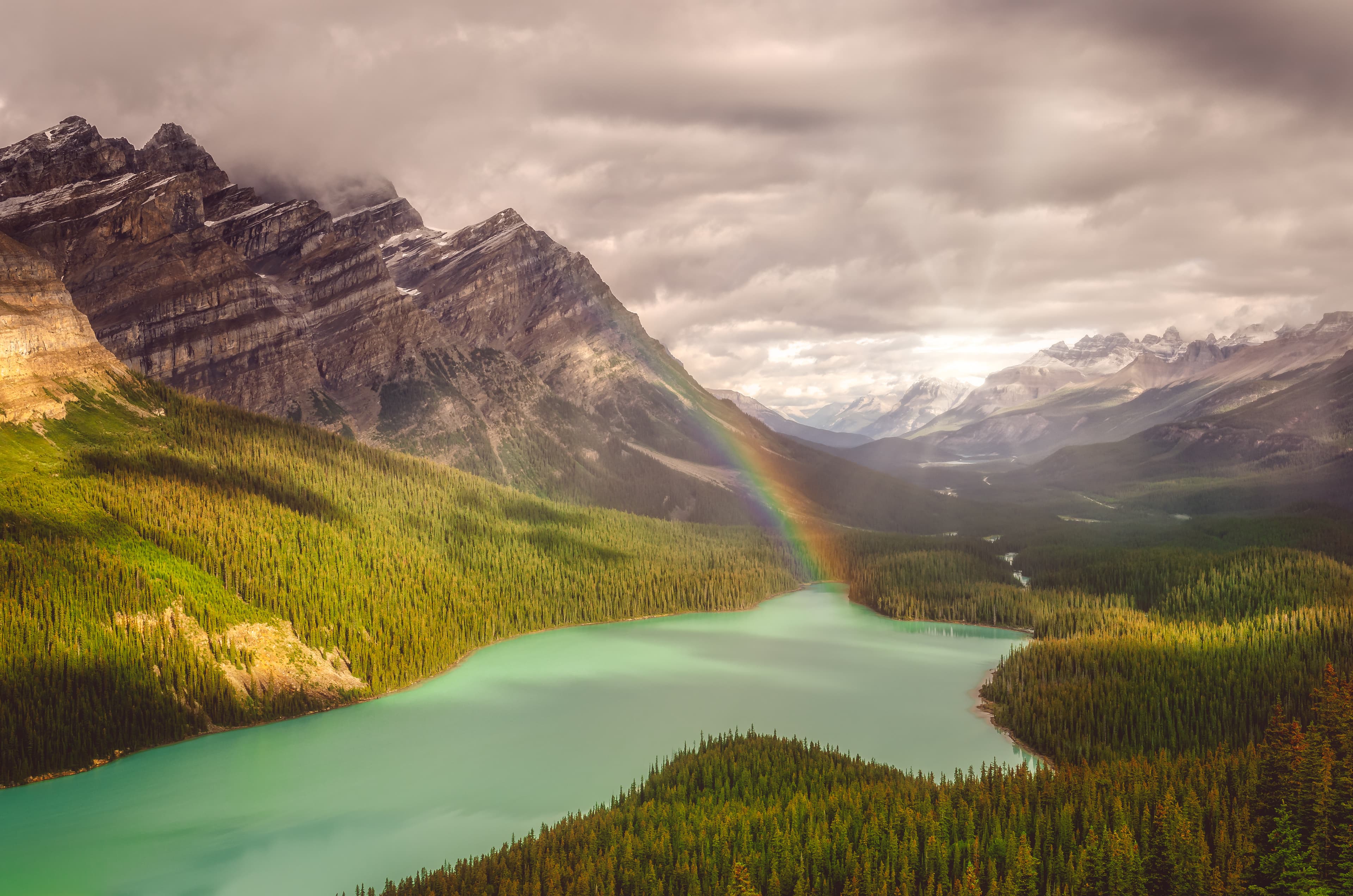 Snecin view of Peyto lake and Rocky mountains with rainbow and sunlight, Alberta, Canada Snecin view of Peyto lake and Rocky mountains with rainbow