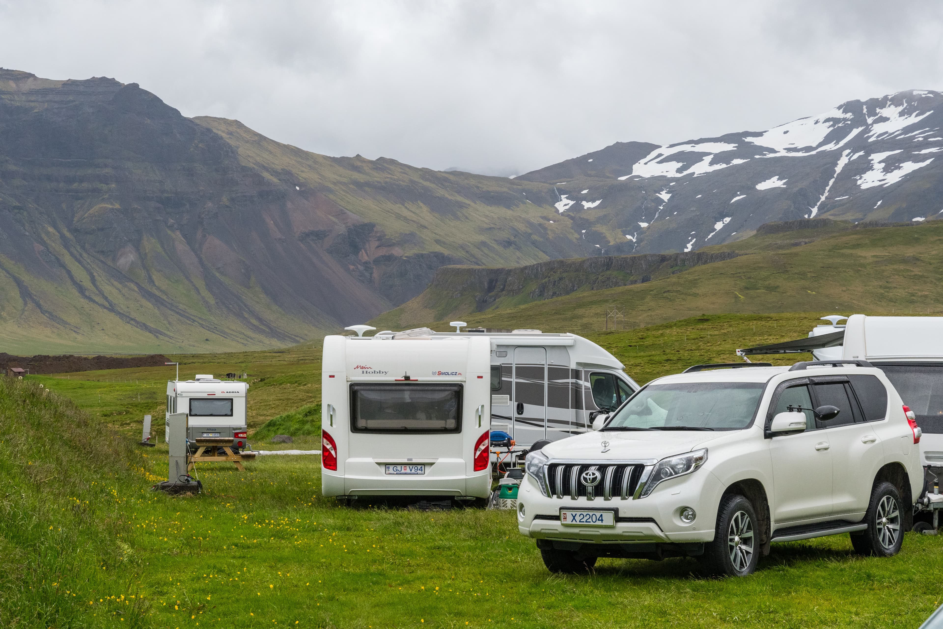 Grundarfjordur Iceland - June 22. 2020: Toyota Land cruiser and caravan on a campsite Toyota Land cruiser and caravan on a campsite