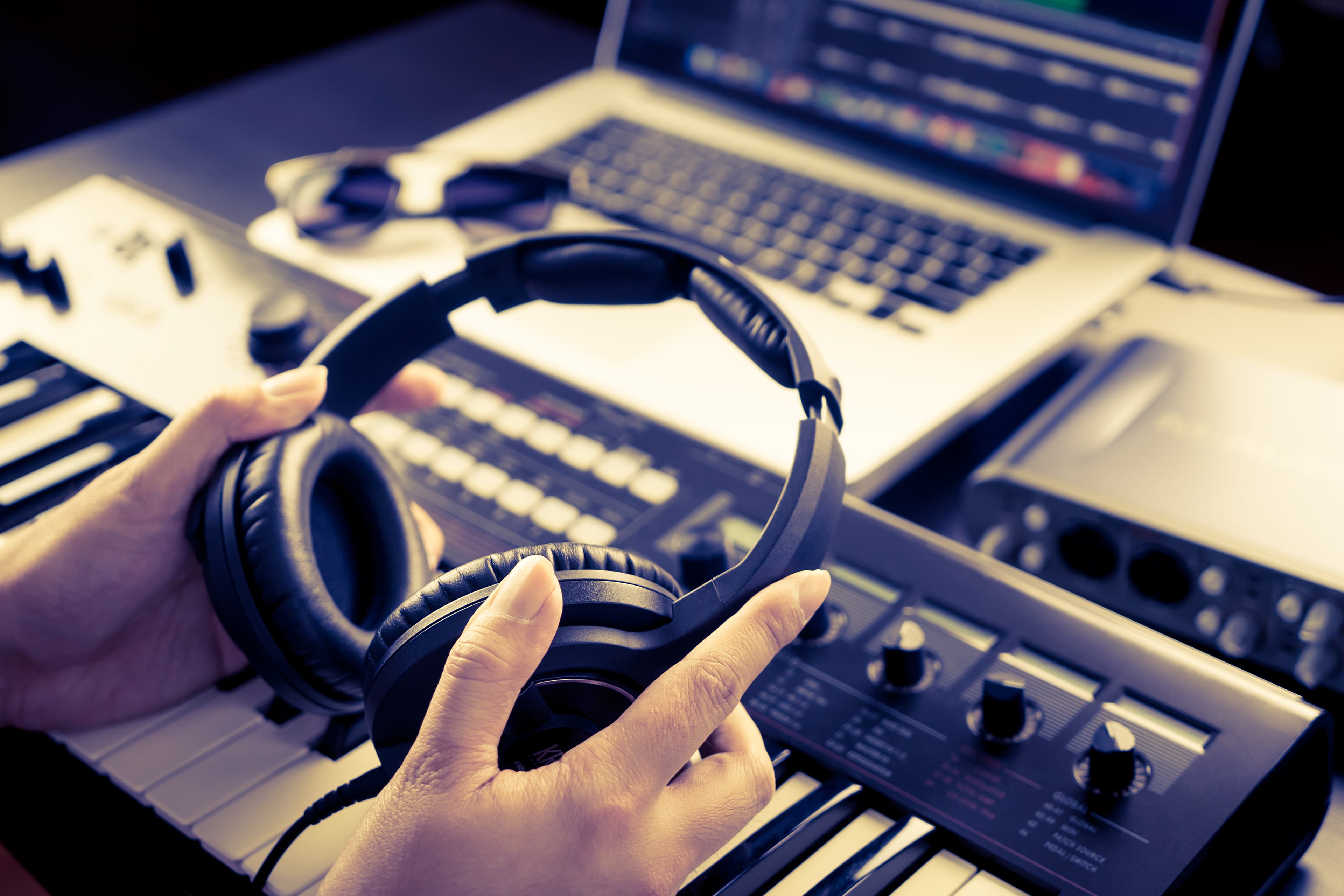 Sound Engineer is picking headphone to start mixing song. Sound Engineer is picking headphone to start mixing song.