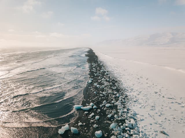 Ice rock with black sand beach at Jokulsarlon beach. Diamond beach in Iceland Ice rock with black sand beach at Jokulsarlon beach. Diamond beach in Iceland