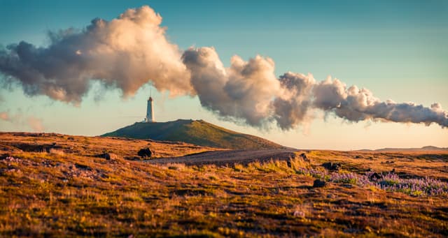 Panoramic summer view of Reykjanes Lighthouse with steam from a Gunnuhver Hot Springs. Exotic evening scene of Iceland, Europe. Traveling concept background.. Panoramic summer view of Reykjanes Lighthouse with steam from a Gunnuhver Hot Springs. Exotic evening scene of Iceland, Europe. Traveling concept background..