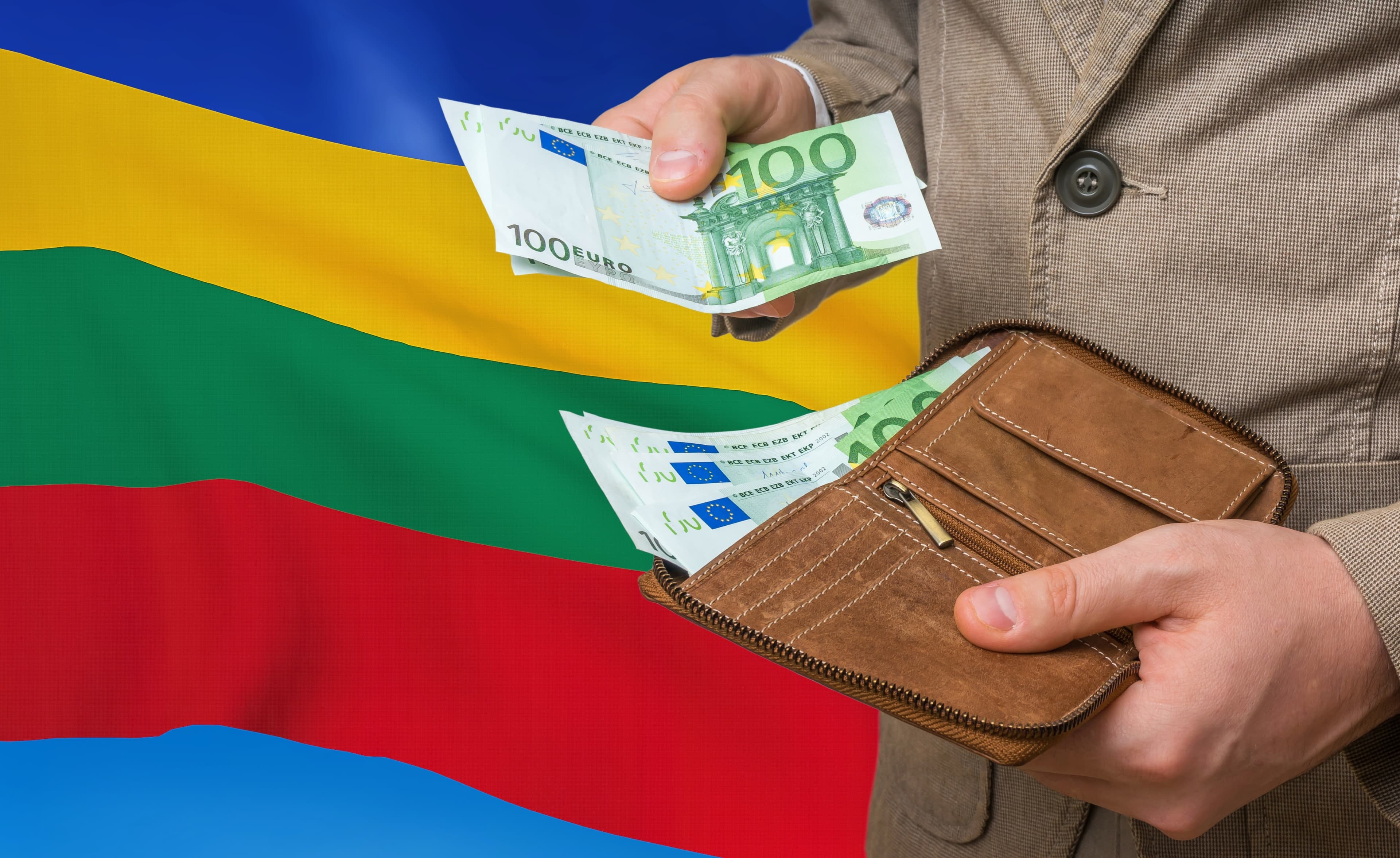 Investing money to Lithuania. Rich man with a lot of money in his hands and national flag on background. Investing money to Lithuania. Rich man with a lot of money.