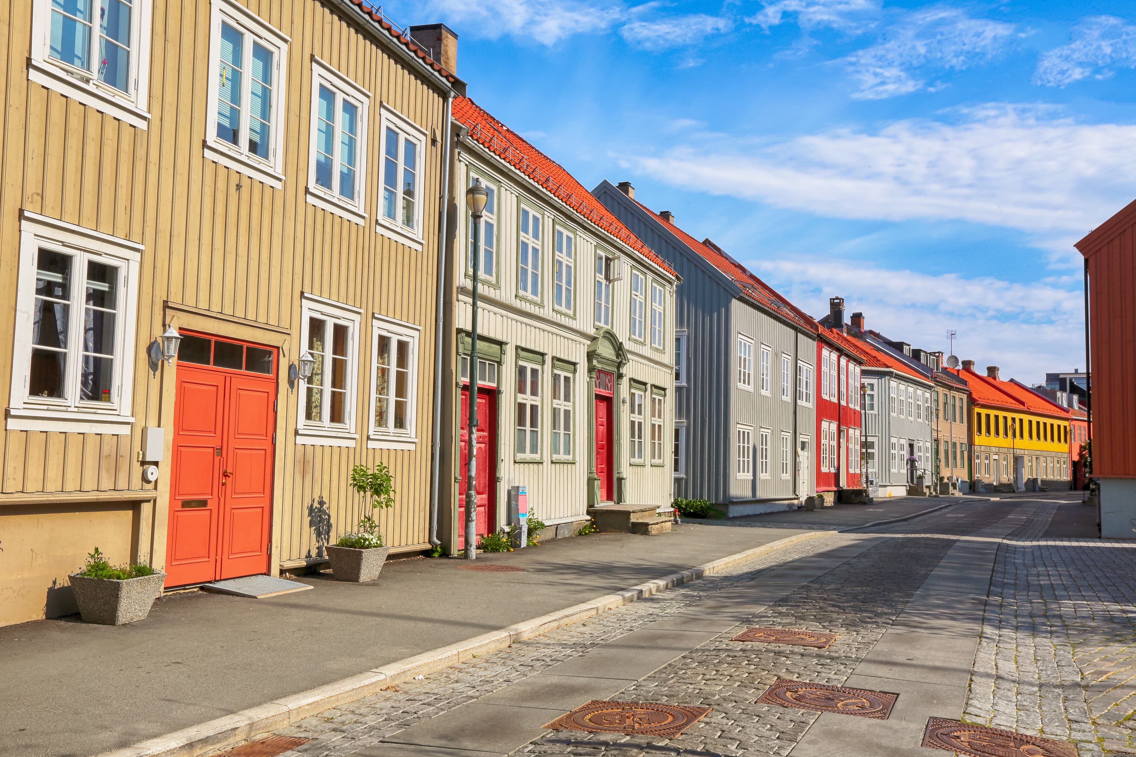 Bakklandet , old neighbourhood in Trondheim, with small wooden houses and narrow streets. it is among the major tourist attractions in the city. Bakklandet , old neighbourhood in Trondheim, with small wooden houses and narrow streets. it is among the major tourist attractions in the city.