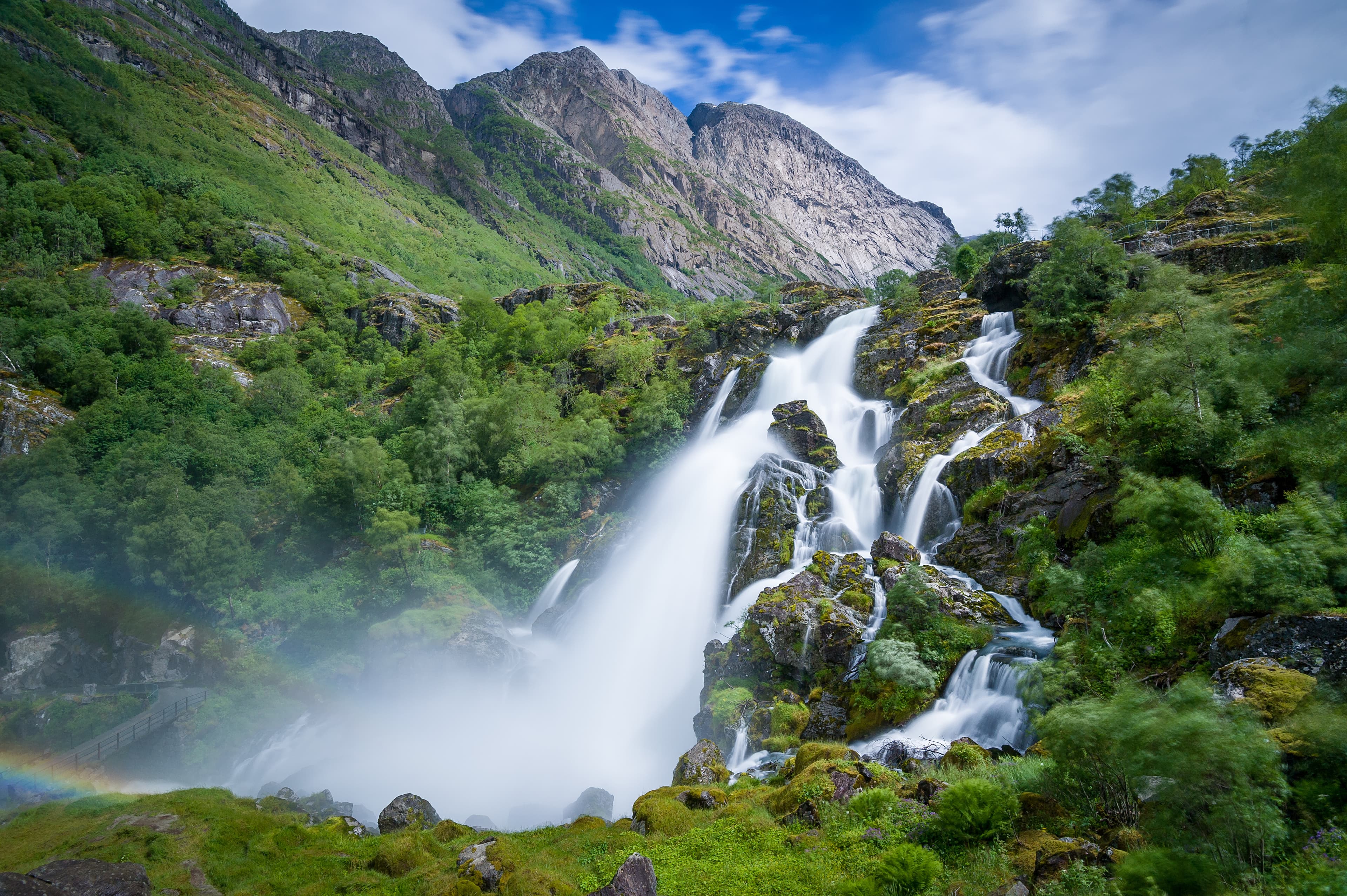 Briksdalsbreen waterfall long exposure photo. Briksdal, Norway national park and popular hiking path to glacier viewpoint. Briksdalsbreen national park waterfall long exposure