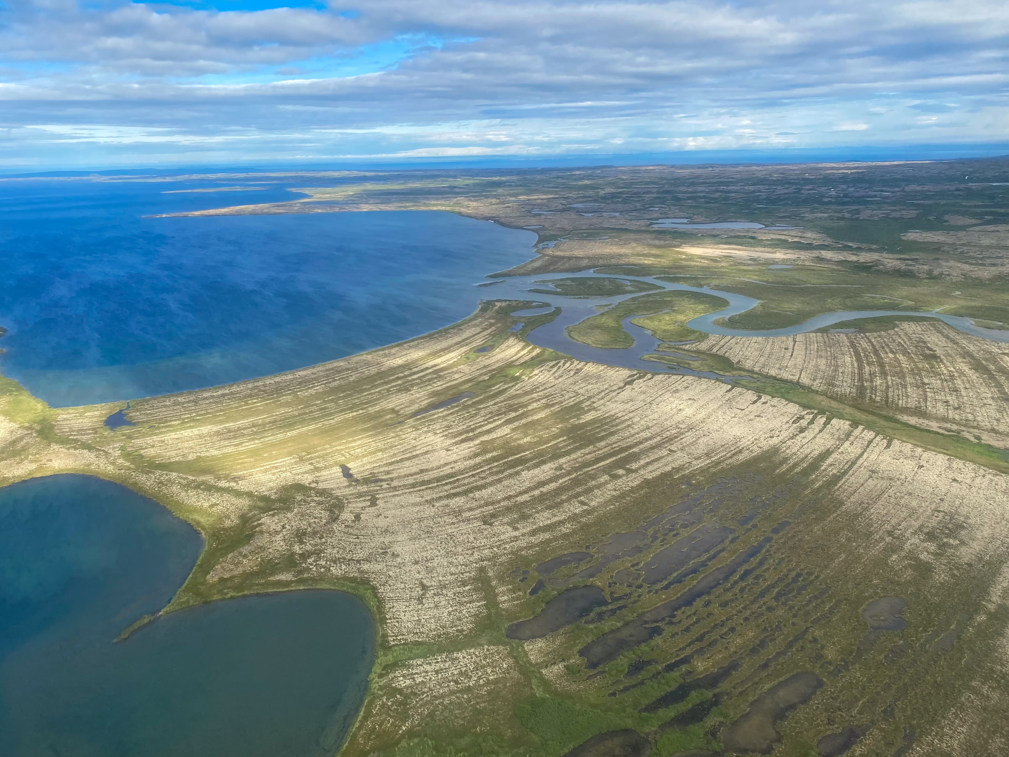 Aerial view of Lake Iliamna with islands, Aleutian mountain range and reflection. Near Pedro Bay, Alaska.
