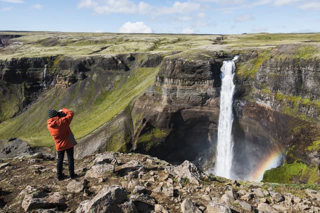Photographer taking picture of Haifoss waterfall, Iceland. Photographer taking picture of Haifoss waterfall, Iceland