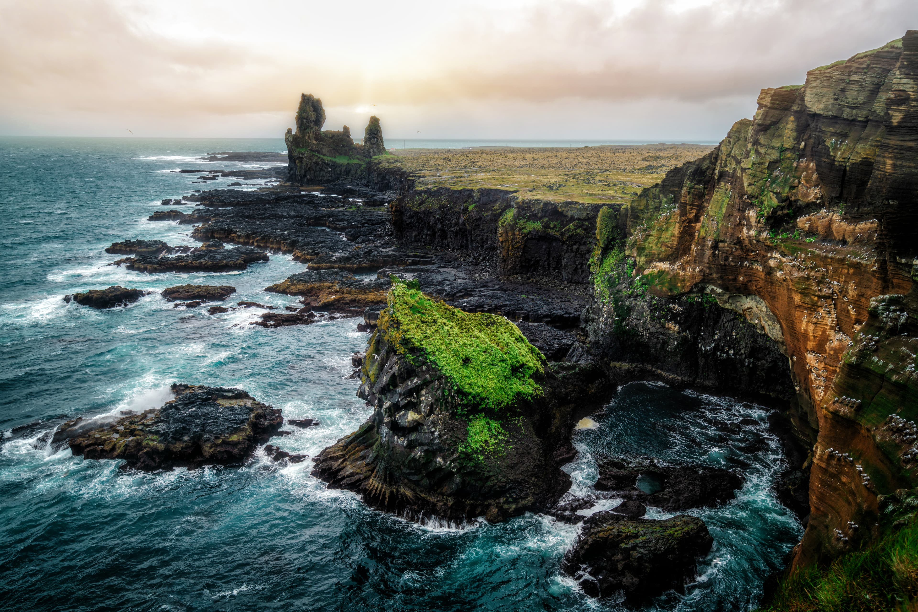 Londrangar in Snaefellsnes National Park, Iceland. Londrangar and hill Svalthufa are remains of a crater, which has been eroded to present form by sea. It is the tourist destination of west Iceland. Londrangar in Snaefellsnes National Park, Iceland. Londrangar and hill Svalthufa are remains of a crater, which has been eroded to present form by sea. It is the tourist destination of west Iceland.