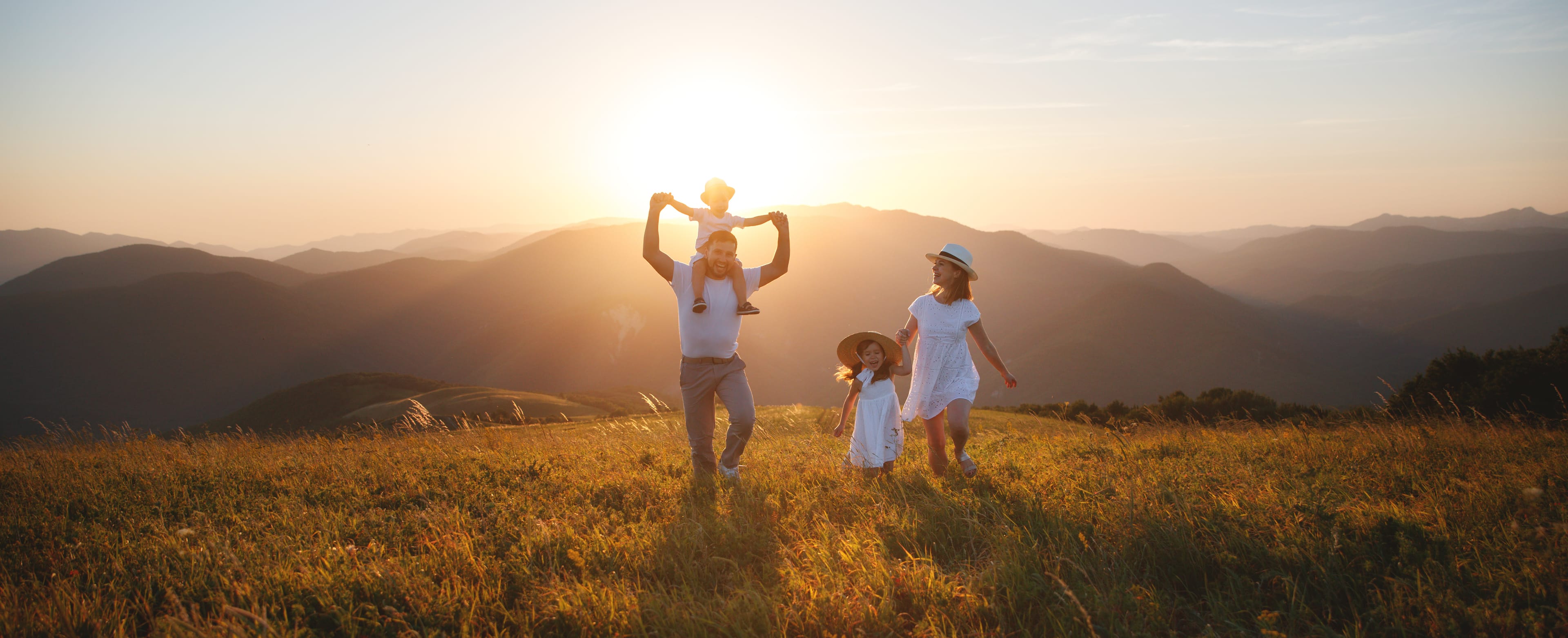 Happy family: mother, father, children son and  daughter on nature  on sunset Happy family: mother, father, children son and daughter on sunset