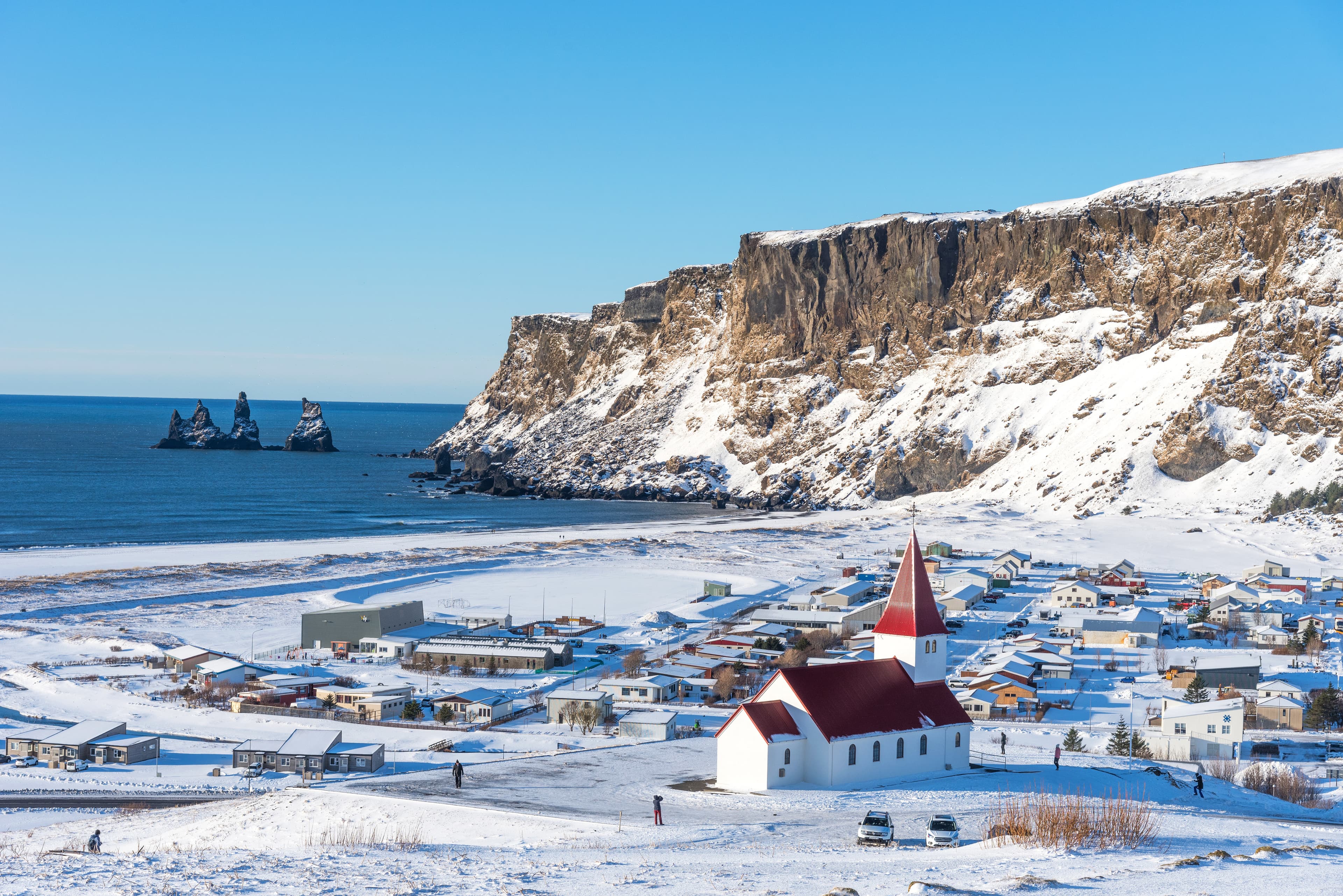 Picturesque aerial view of Vik I Myrdal church at the top of the hill in Iceland in winter. Panoramic beautiful view of village Vik and Myrdal church in winter in Iceland Picturesque aerial view of Vik I Myrdal church at the top of the hill in Iceland in winter.