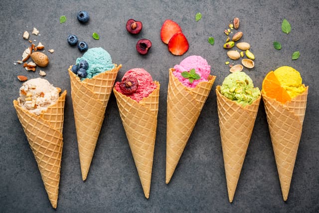 Various of ice cream flavor in cones blueberry ,strawberry ,pistachio ,almond ,orange and cherry setup on dark stone background . Summer and Sweet menu concept. Various of ice cream flavor in cones blueberry ,strawberry ,pistachio ,almond ,orange and cherry setup on dark stone background . Summer and Sweet menu concept.