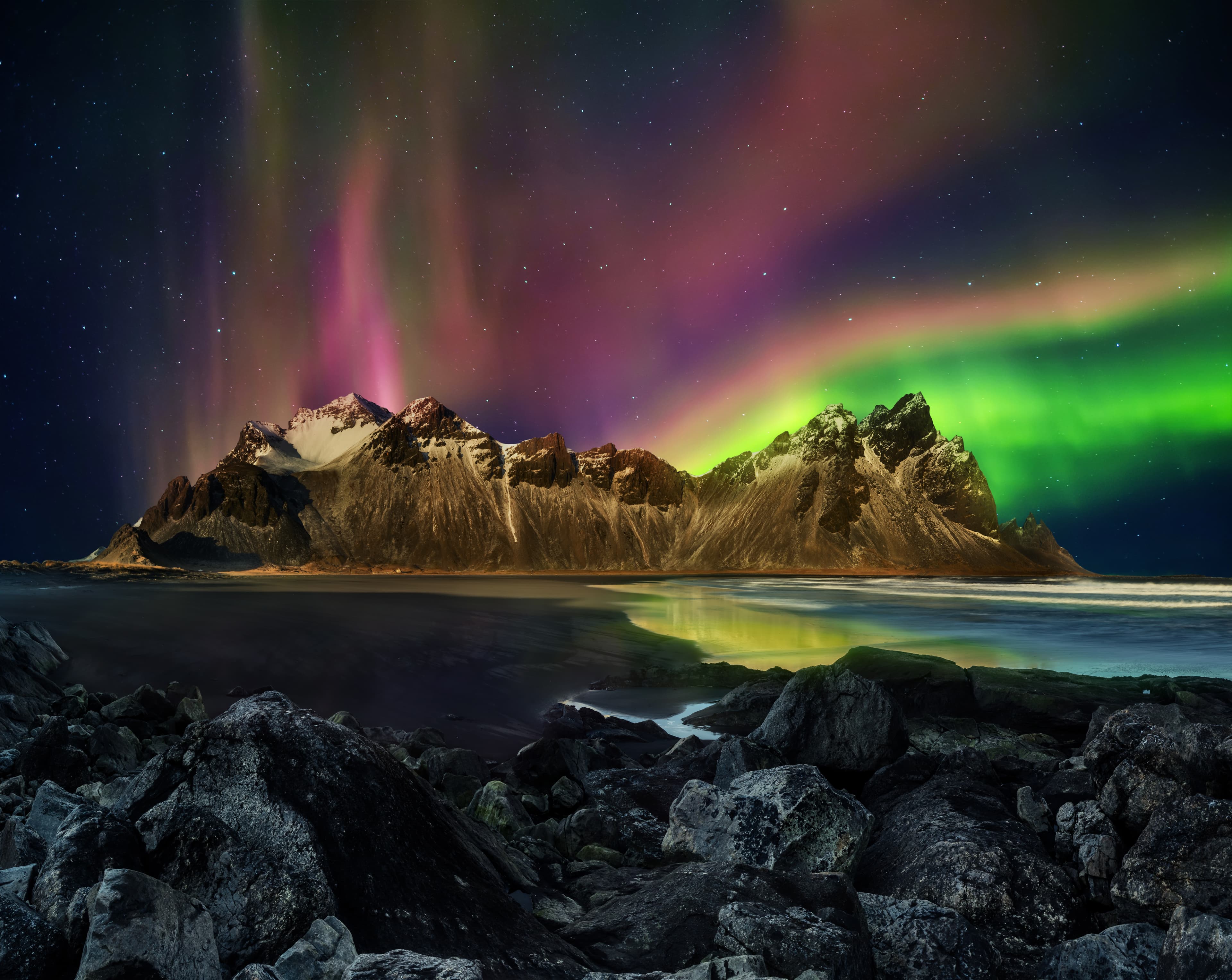 Vestrahorn Stockknes mountain range with aurora borealis, Iceland. One of the most beautiful famous nature heritage in Iceland. Vestrahorn Stockknes mountain range with aurora borealis, Iceland.