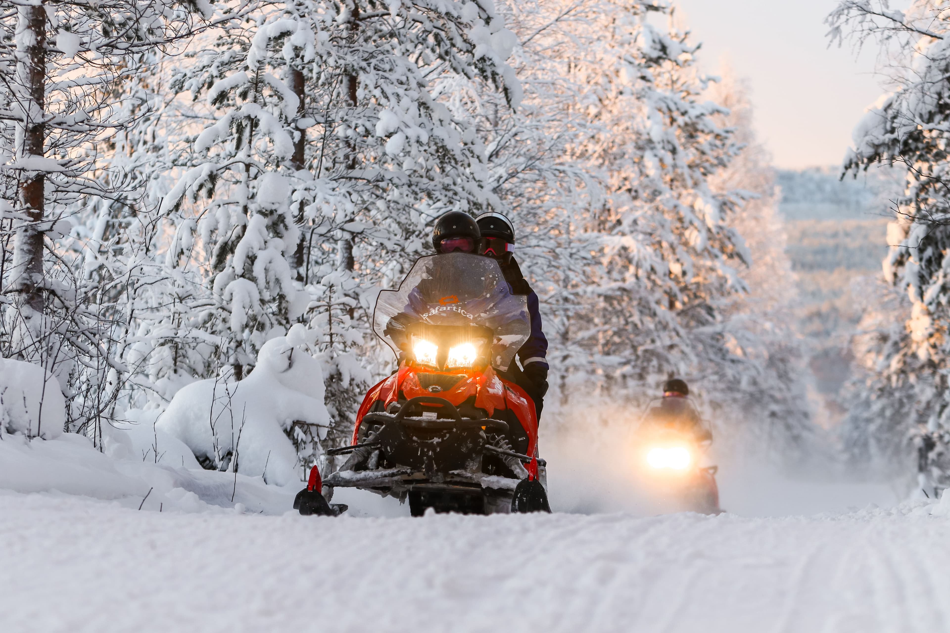 Snowmobiling-in-Finland-forest-during-winter