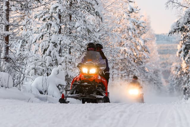 Snowmobiling-in-Finland-forest-during-winter