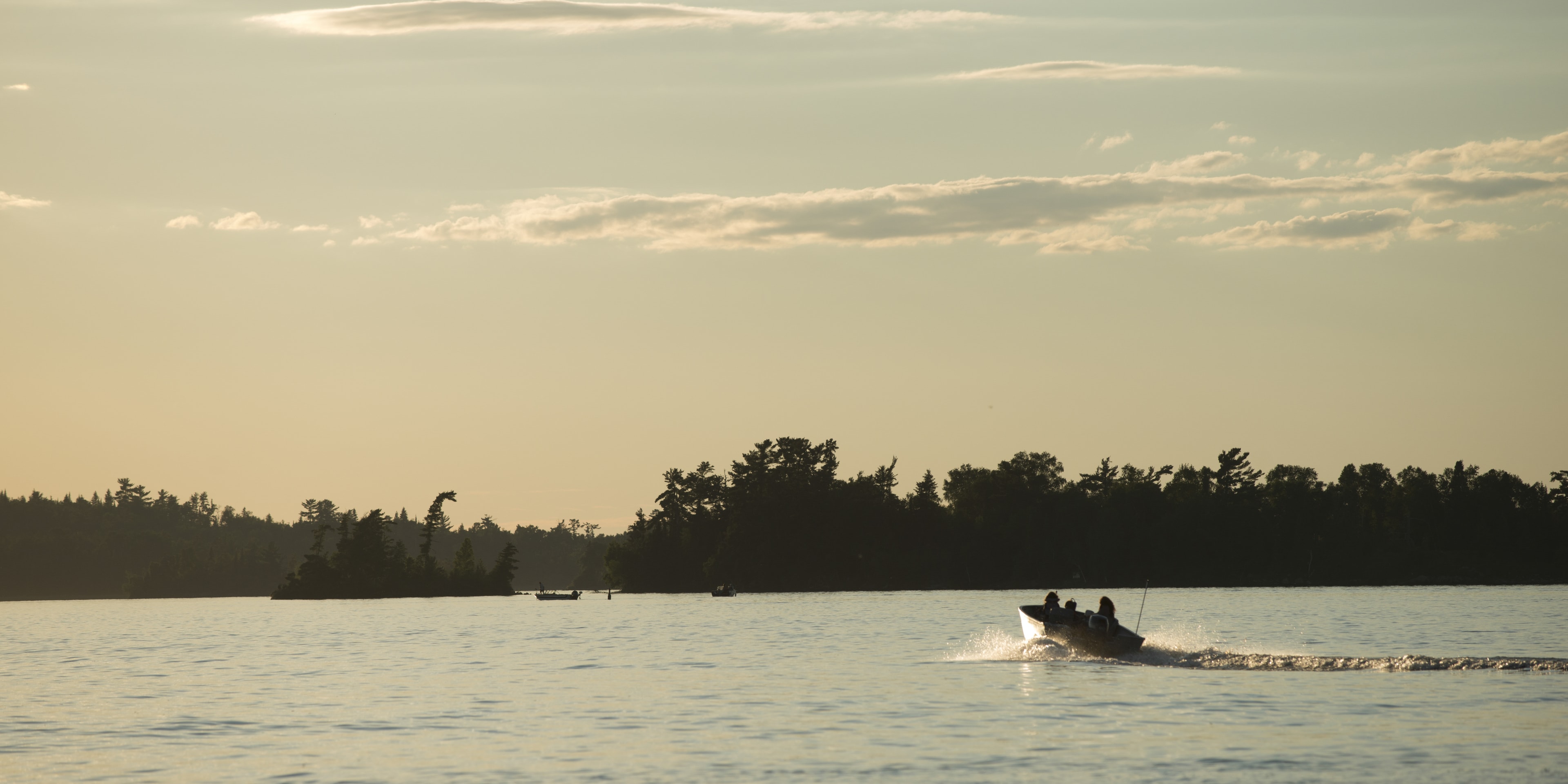 Boat moving in a lake, Lake of The Woods, Ontario, Canada Boat moving in a lake, Lake of The Woods, Ontario, Canada