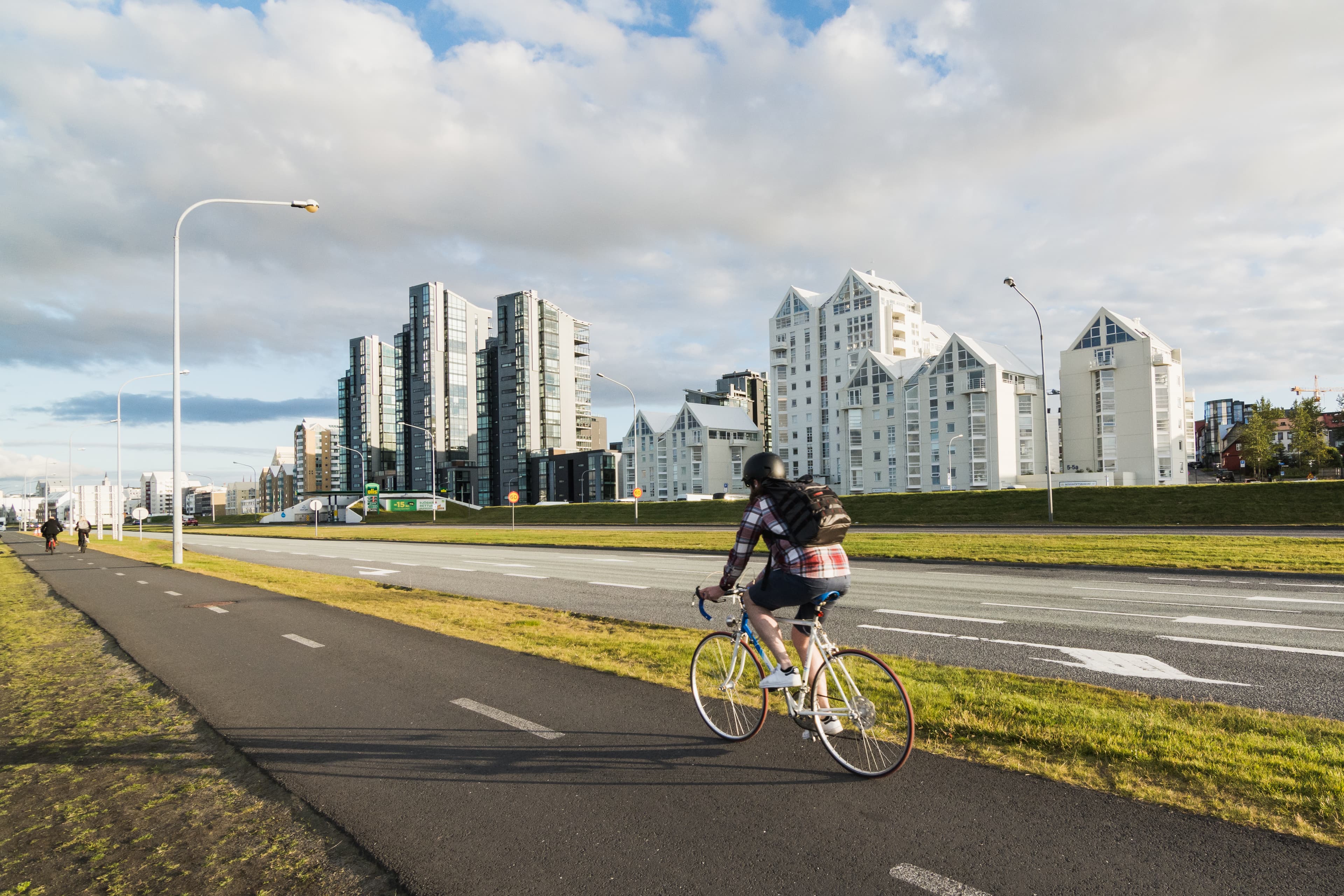 REYKJAVIK, ICELAND - AUGUST 2018: man riding a bicycle Saebraut street. REYKJAVIK, ICELAND - AUGUST 2018: man riding a bicycle Saebraut street