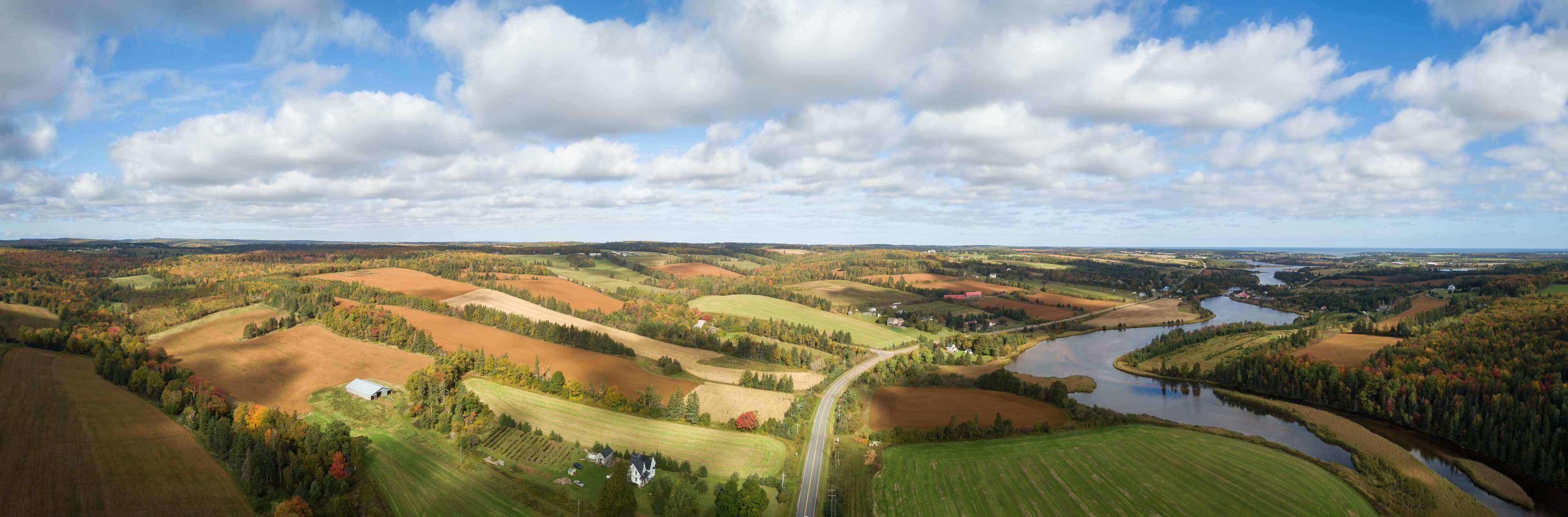 Aerial panoramic landscape view of Farm Fields during a sunny day. Taken near New Glasgow, Prince Edward Island, Canada. Aerial panoramic landscape view of Farm Fields during a sunny day. Taken near New Glasgow, Prince Edward Island, Canada.
