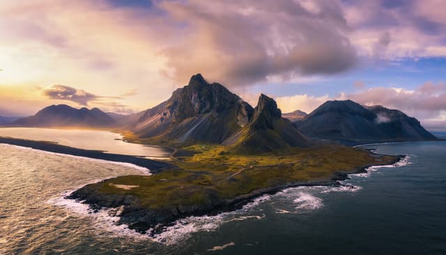 Aerial View of the Eystrahorn with Krossanesfjall Mountain and a nearby black sand beach in Iceland at sunset. Aerial View of the Eystrahorn with Krossanesfjall Mountain in Iceland at sunset
