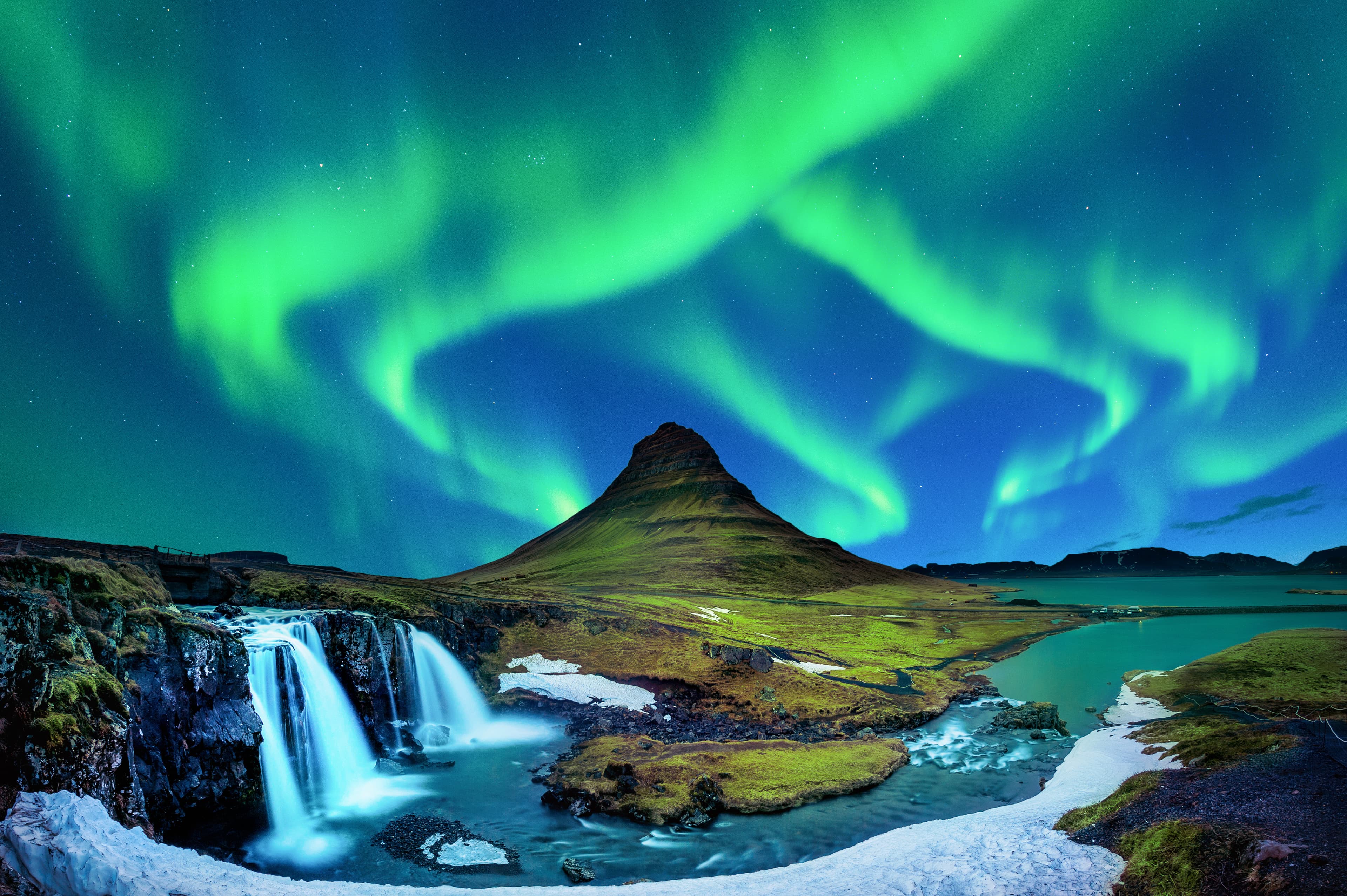 Northern Light, Aurora borealis at Kirkjufell in Iceland. Kirkjufell mountains in winter. Iceland-norther-lights-above-Kirkjufell-mountain-and-waterfall