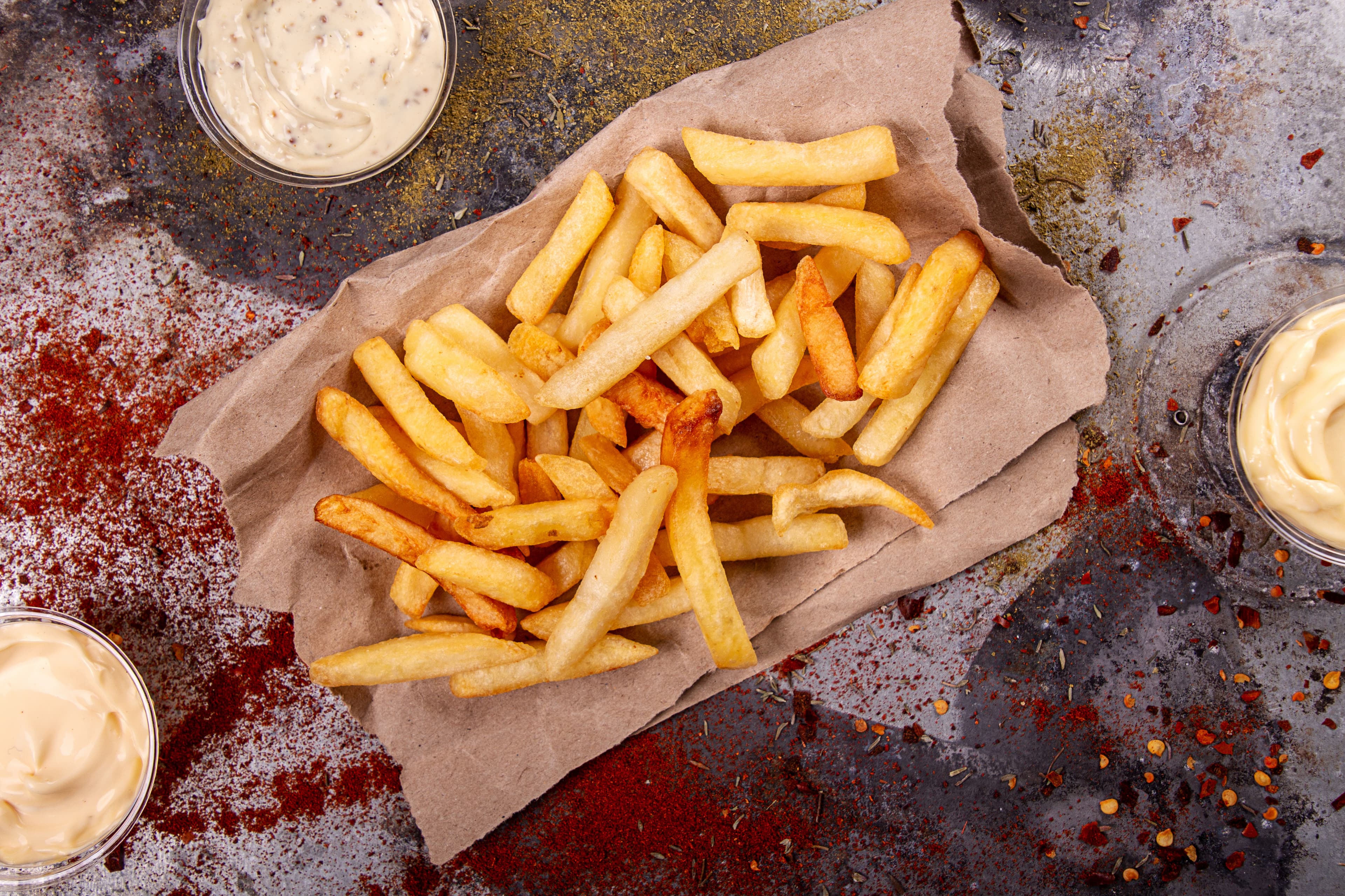 French fries chips potato and sauces on black stone slate over rusty background. top view New Brunswick Region 05