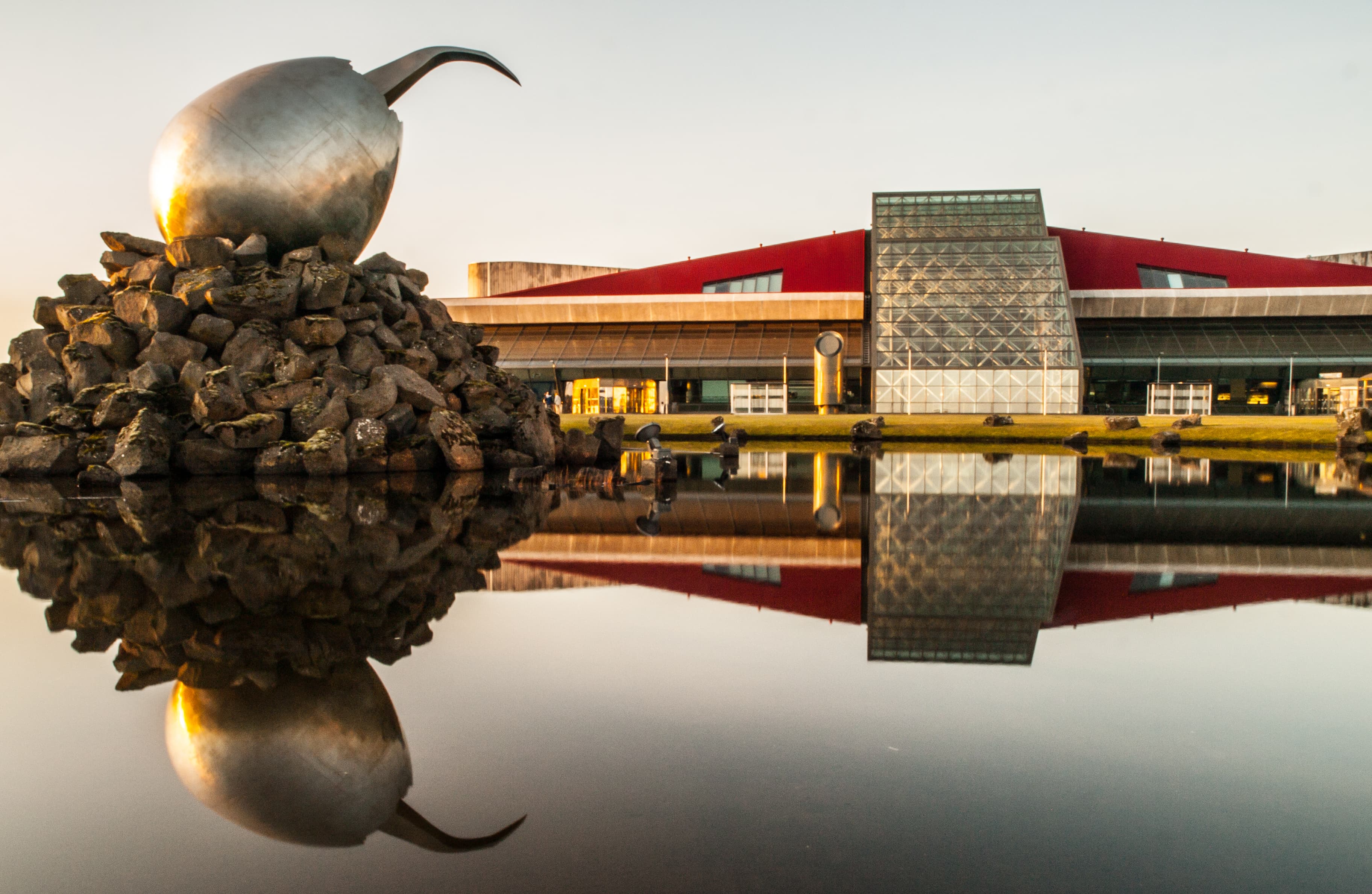 REYKJAVIK, ICELAND - SEPTEMBER 9, 2011: Building exterior and The Jet Nest artwork - big metal egg. Keflavik International Airport, the main airport in Iceland. REYKJAVIK, ICELAND - SEPTEMBER 9, 2011: Building exterior and The Jet Nest artwork - big metal egg. Keflavik International Airport, the main airport in Iceland