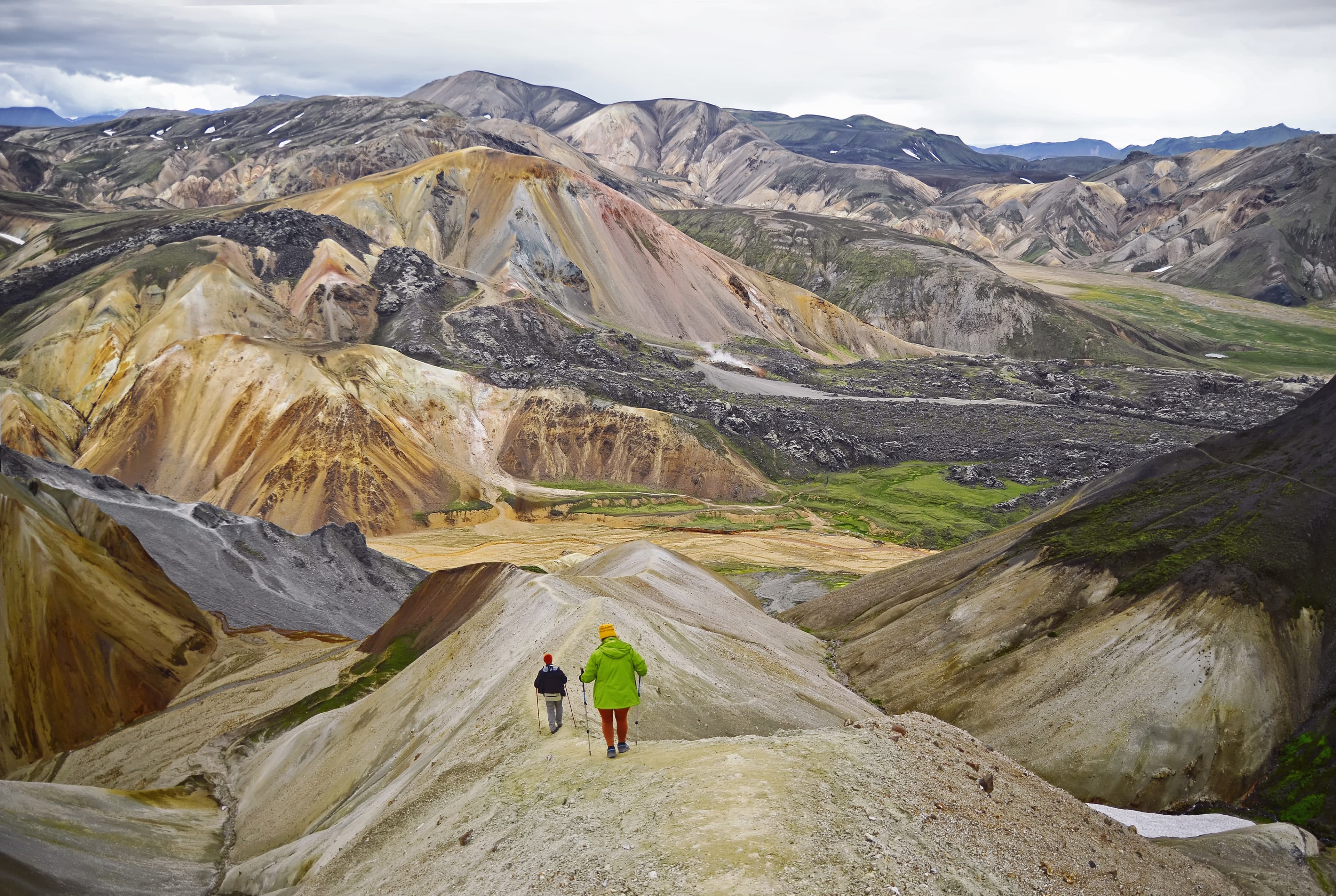 Group of hikers in the mountains . Icelandic landscape -  view  on   amazing  valley National Park Landmannalaugar Group of hikers in the mountains . Icelandic landscape -  view  on   amazing  valley National Park Landmannalaugar